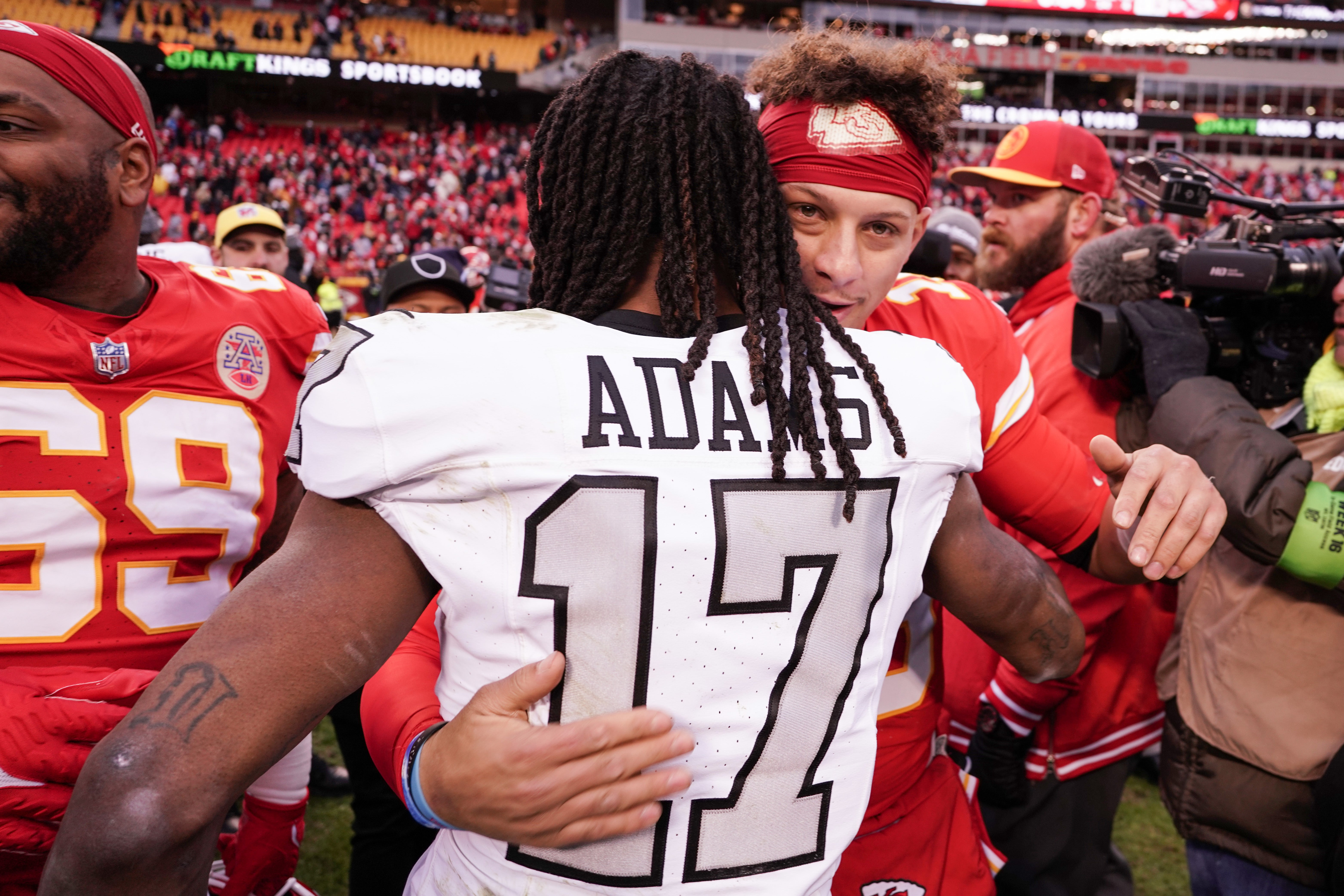 Dec 25, 2023; Kansas City, Missouri, USA; Kansas City Chiefs quarterback Patrick Mahomes (15) embraces Las Vegas Raiders wide receiver Davante Adams (17) after the game at GEHA Field at Arrowhead Stadium.