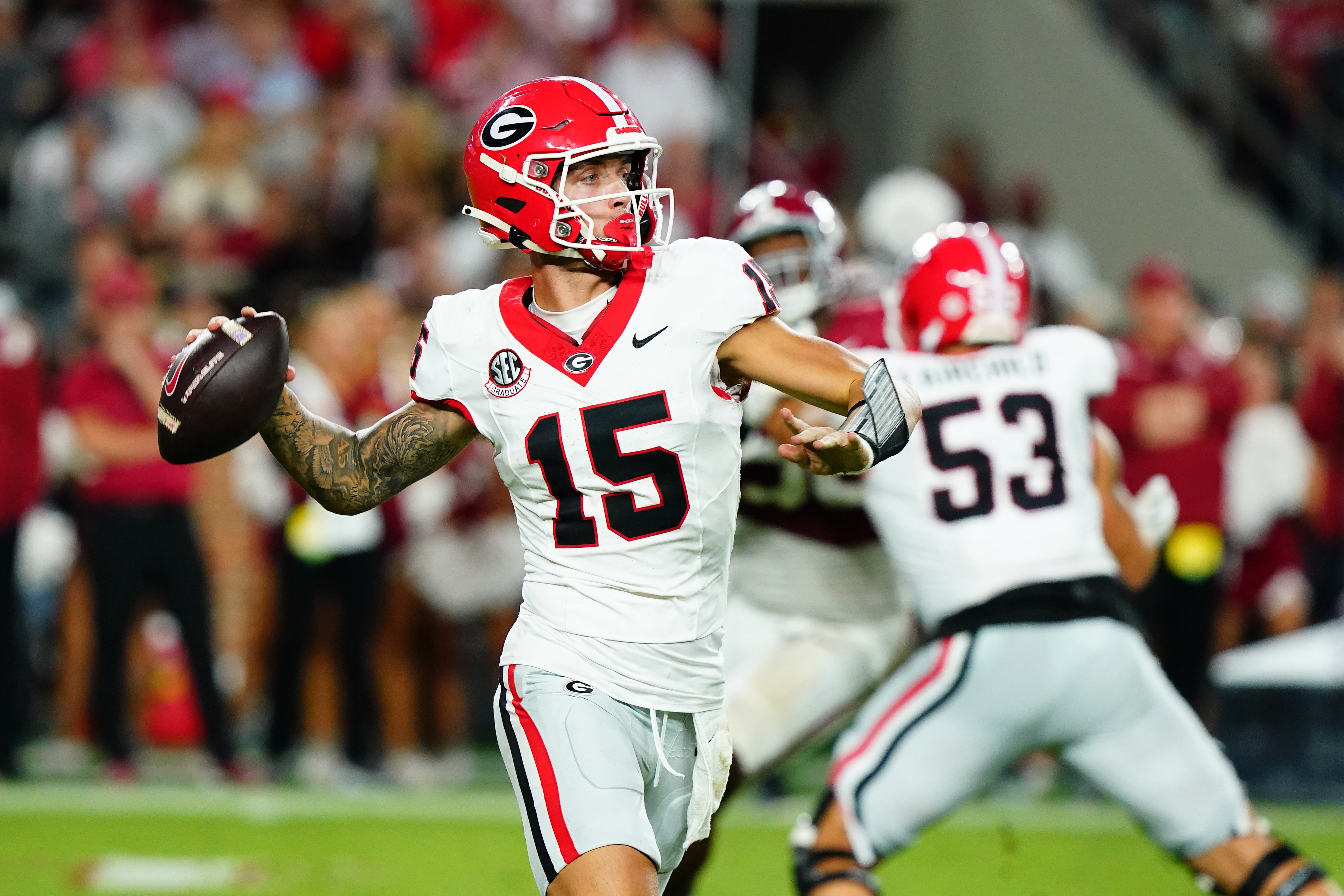 Georgia Bulldogs quarterback Carson Beck (15) rolls out to throw against the Alabama Crimson Tide during the third quarter at Bryant-Denny Stadium.