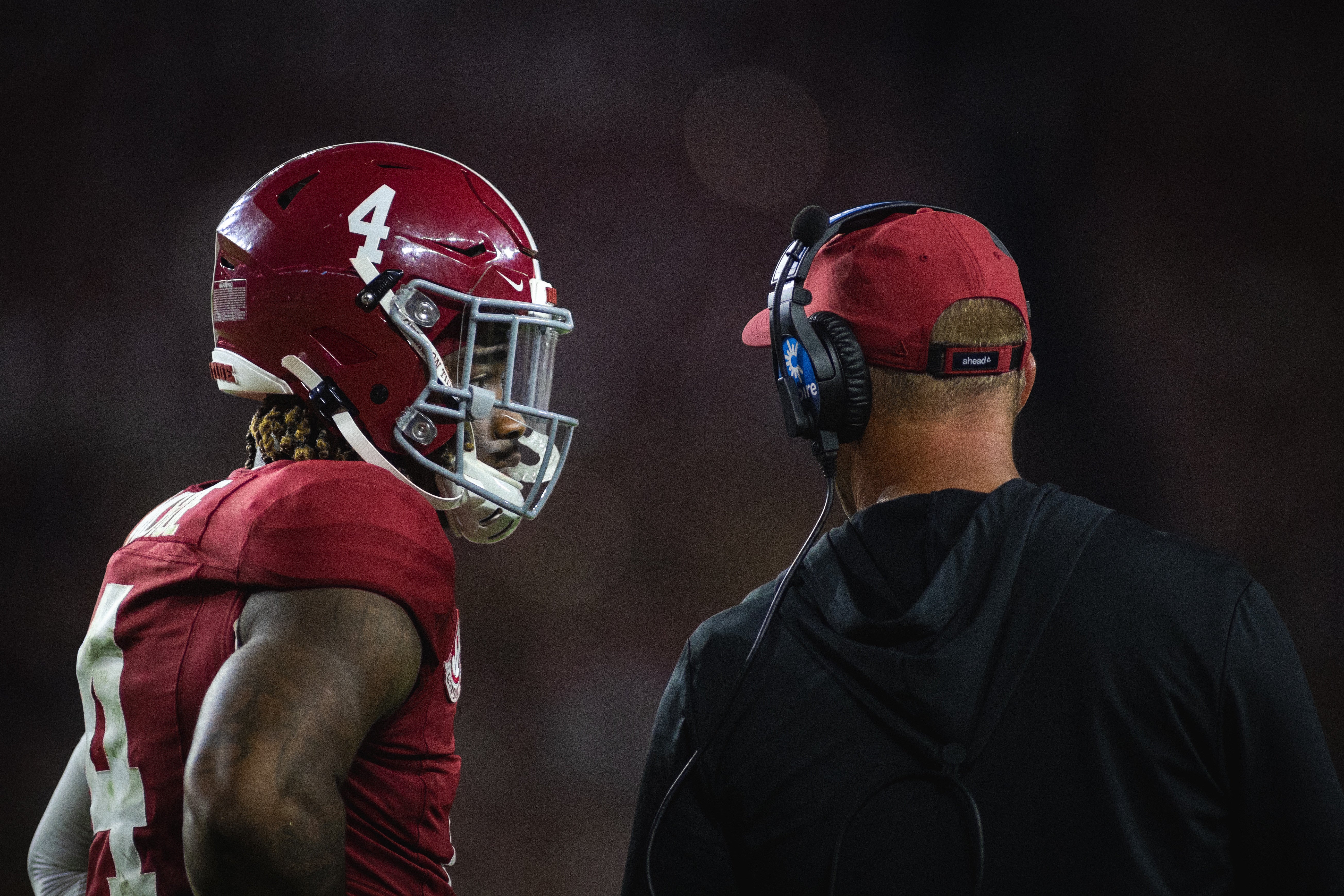 Sep 28, 2024; Tuscaloosa, Alabama, USA; Alabama Crimson Tide quarterback Jalen Milroe (4) talks with head coach Kalen DeBoer during a timeout in the third quarter against the Georgia Bulldogs at Bryant-Denny Stadium.