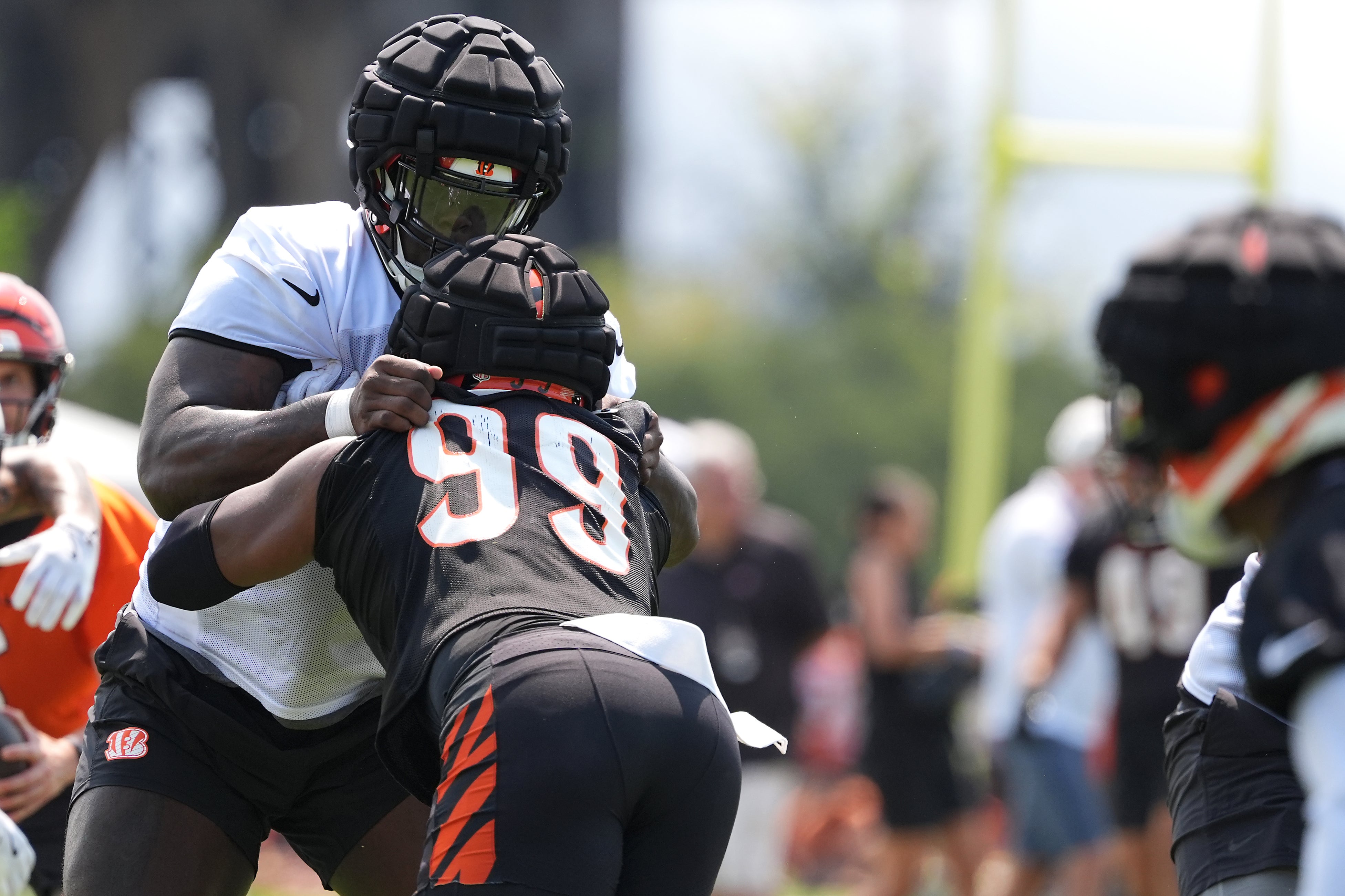 Jul 26, 2024; Cincinnati, OH, USA; Cincinnati Bengals offensive tackle Amarius Mims (71) blocks against defensive end Myles Murphy (99) during training camp practice at Kettering Health Practice Fields.