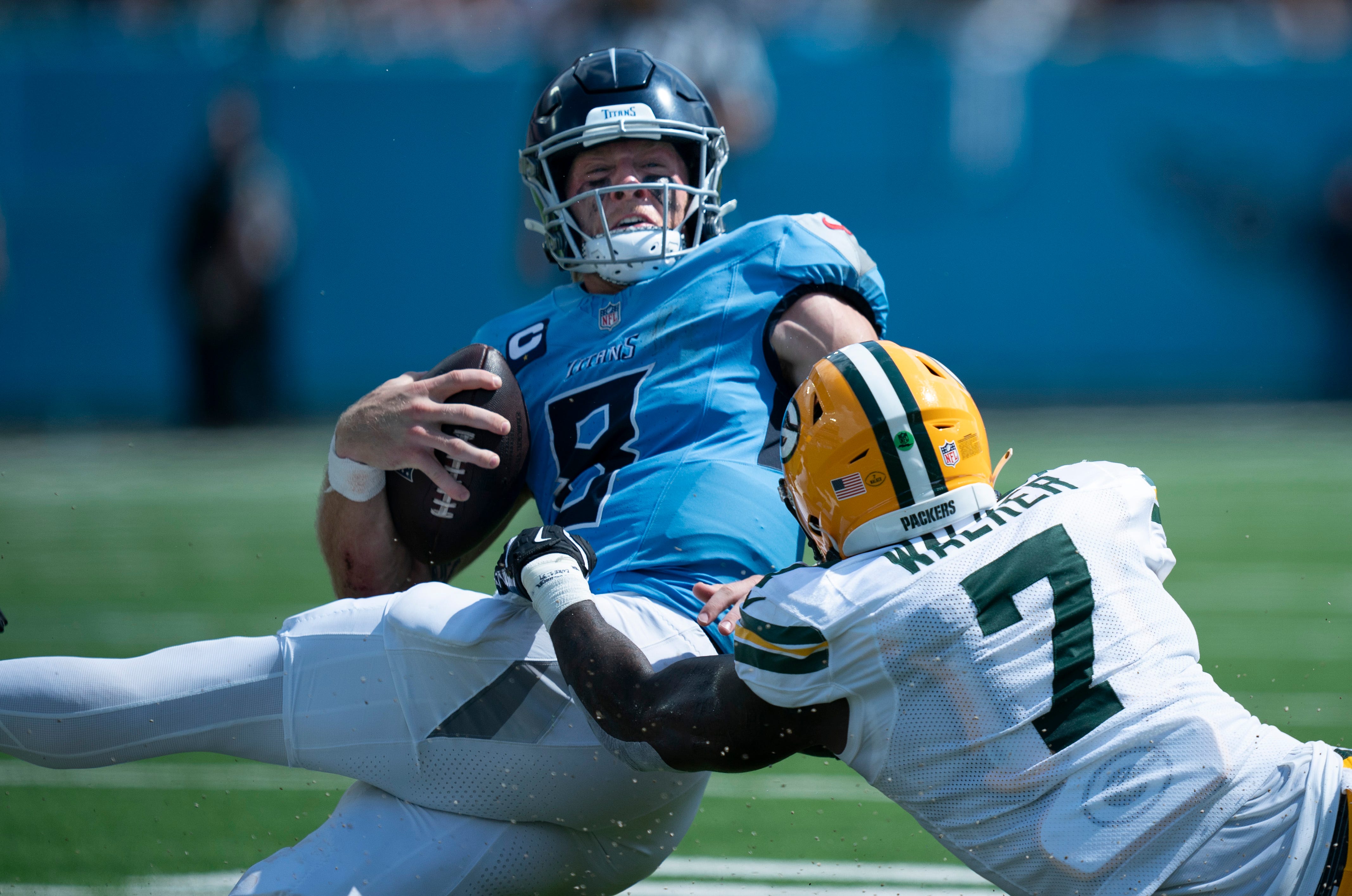Green Bay Packers linebacker Quay Walker (7) tackles Tennessee Titans quarterback Will Levis (8) short of the first down on a fourth-down play in the third quarter during their game at Nissan Stadium in Nashville, Tenn., Sunday, Sept. 22, 2024.