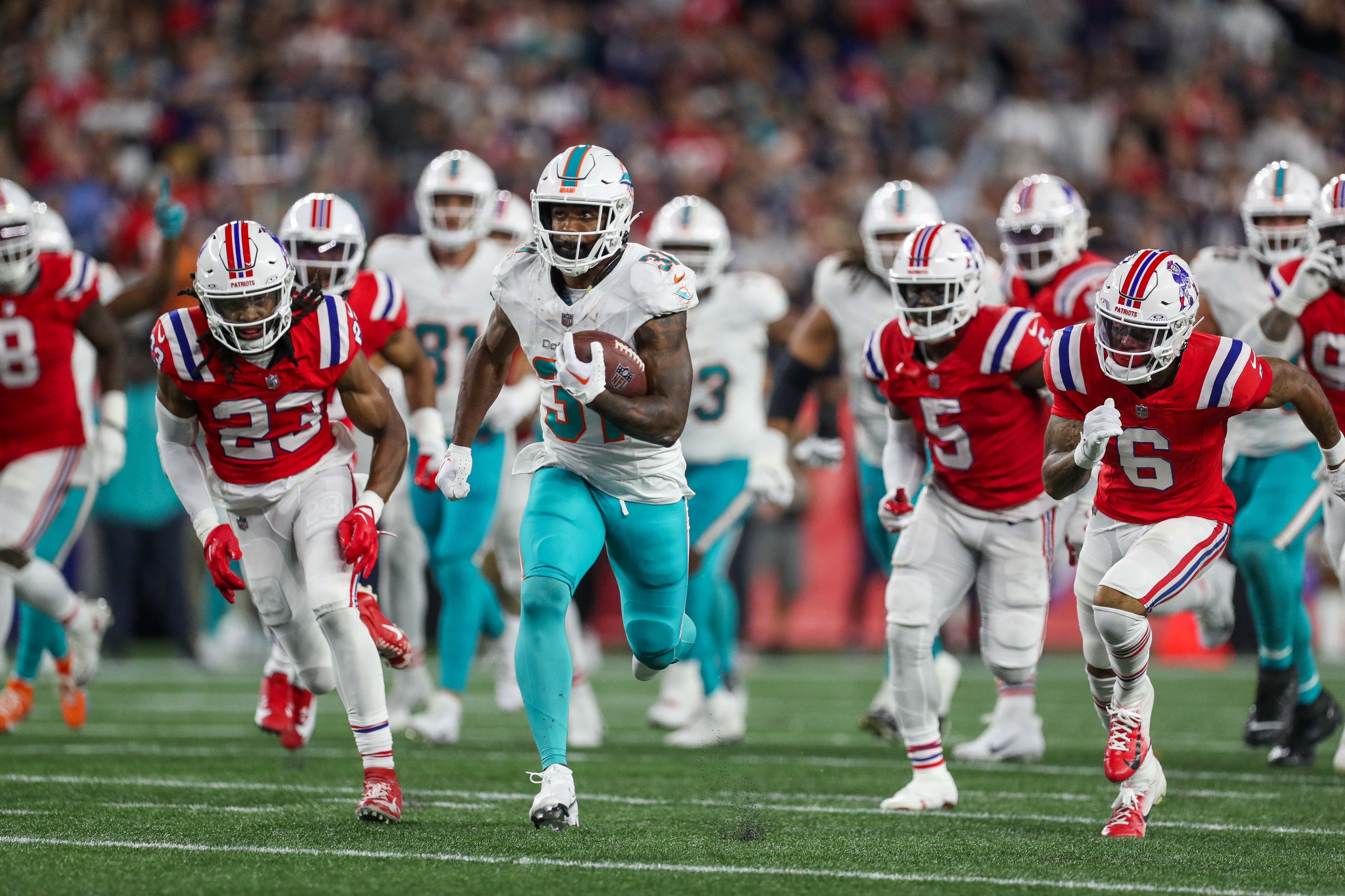 Sep 17, 2023; Foxborough, Massachusetts, USA; Miami Dolphins running back Raheem Mostert (31) runs the ball for a touchdown during the second half against the New England Patriots at Gillette Stadium.