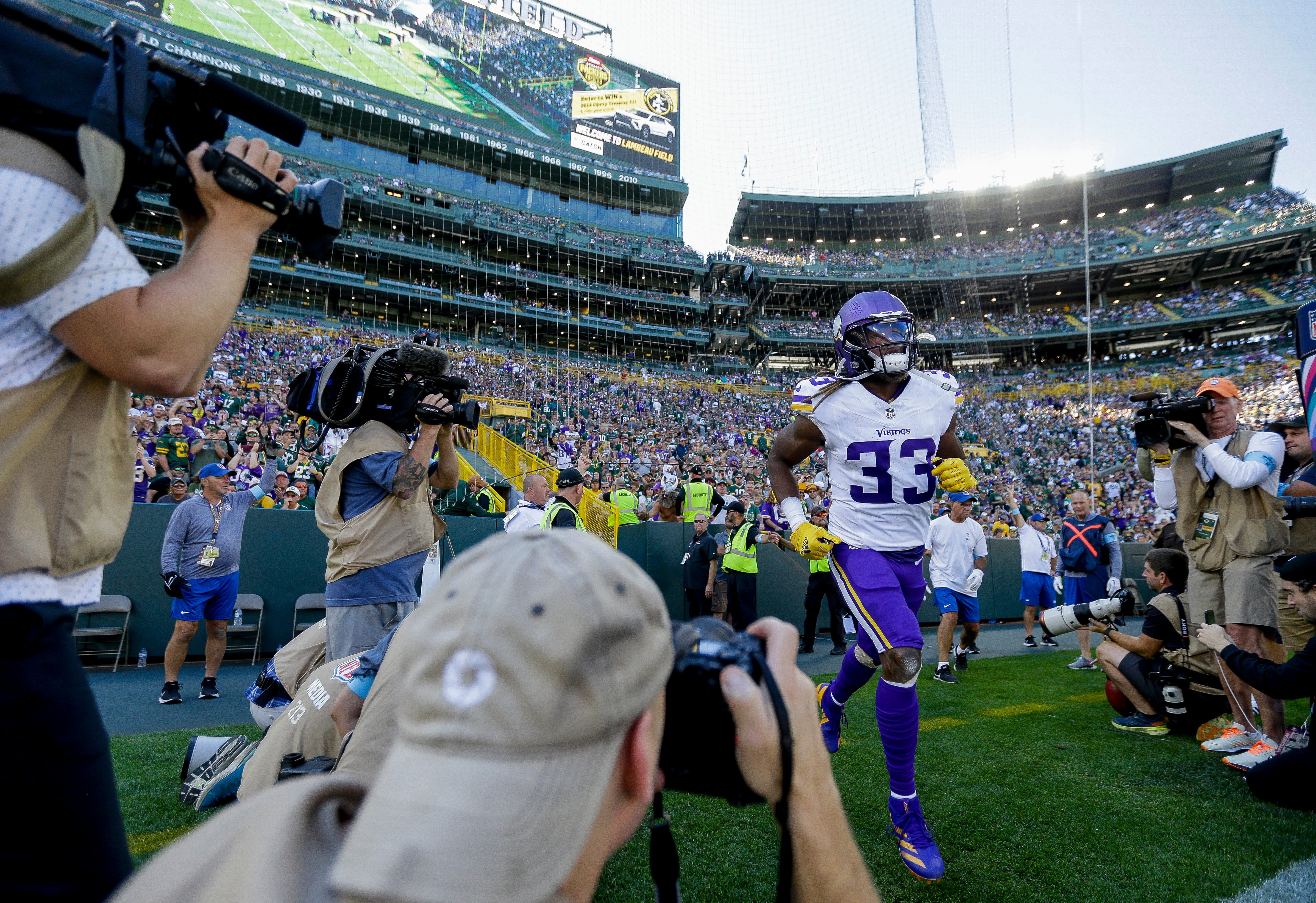 Minnesota Vikings running back Aaron Jones (33) runs onto the field before a game against the Green Bay Packers on Sunday, September 29, 2024, at Lambeau Field in Green Bay, Wis. The Vikings won the game, 31-29.
