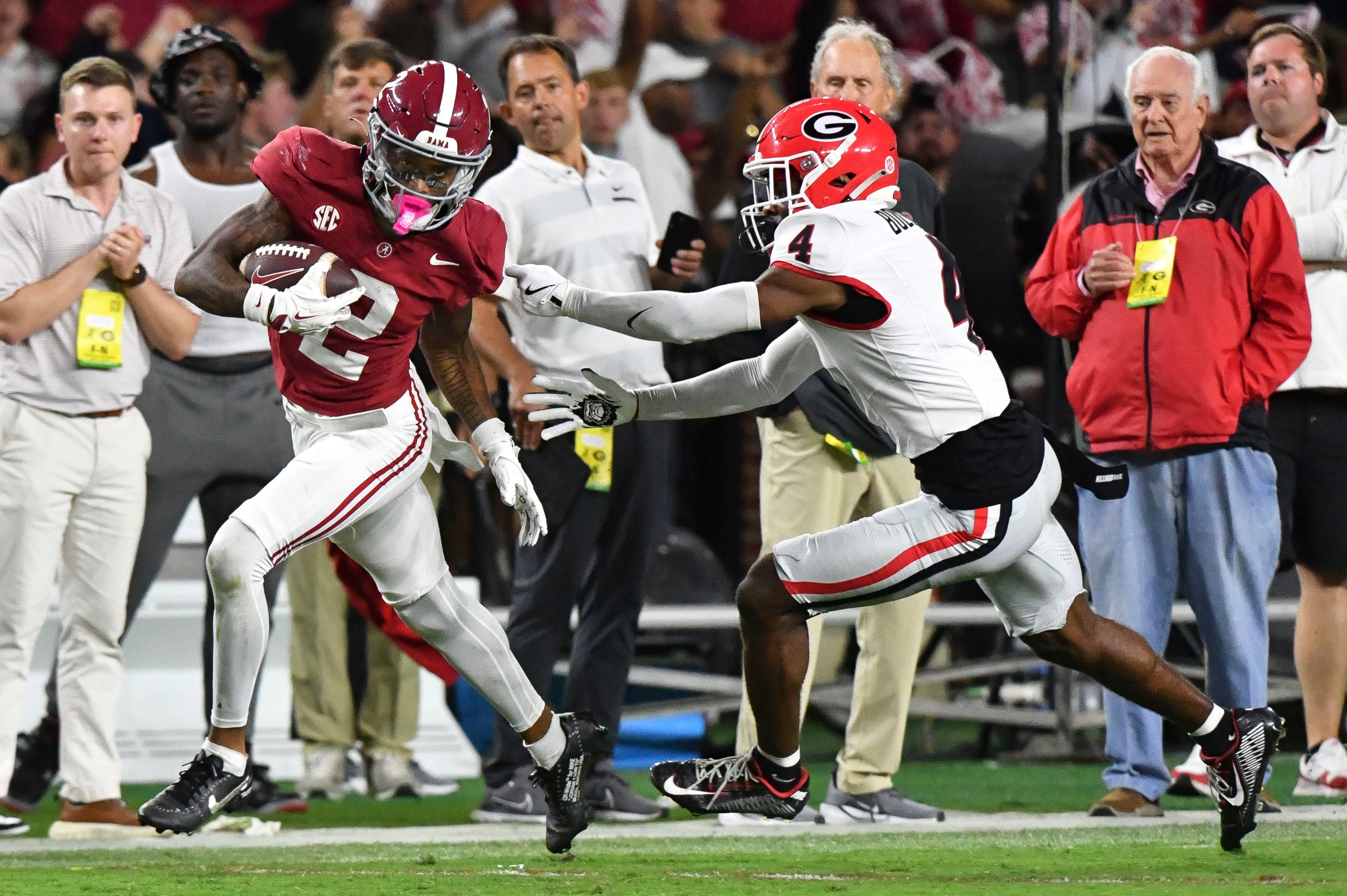Sep 28, 2024; Tuscaloosa, Alabama, USA; Alabama Crimson Tide wide receiver Ryan Williams (2) breaks a tackle by Georgia Bulldogs defensive back KJ Bolden (4) to score a touchdown that put Alabama ahead in the fourth quarter at Bryant-Denny Stadium. Alabama defeated Georgia 41-34.