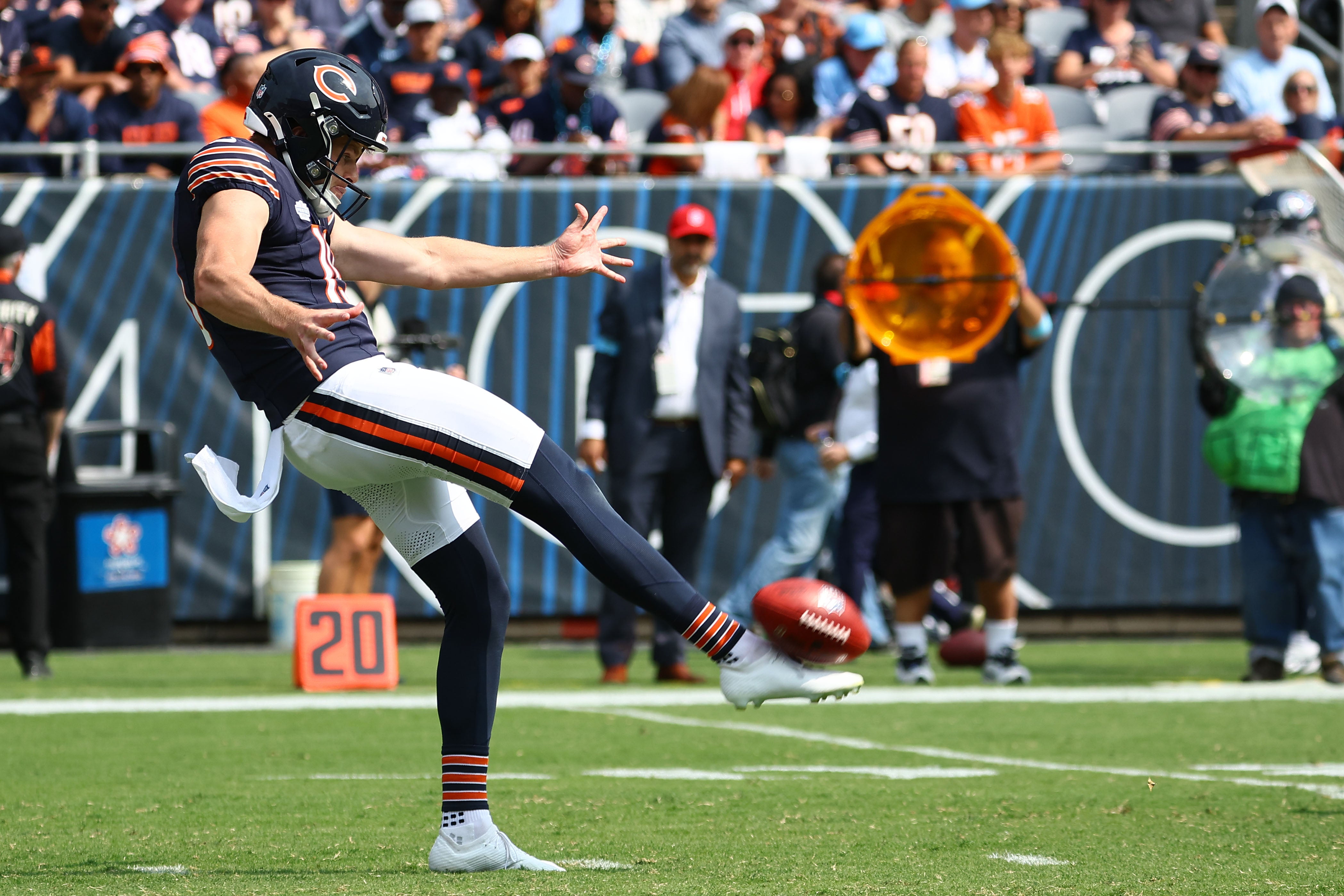 Sep 8, 2024; Chicago, Illinois, USA; Chicago Bears punter Tory Taylor (19) punts the ball against the Tennessee Titans during the second quarter at Soldier Field.