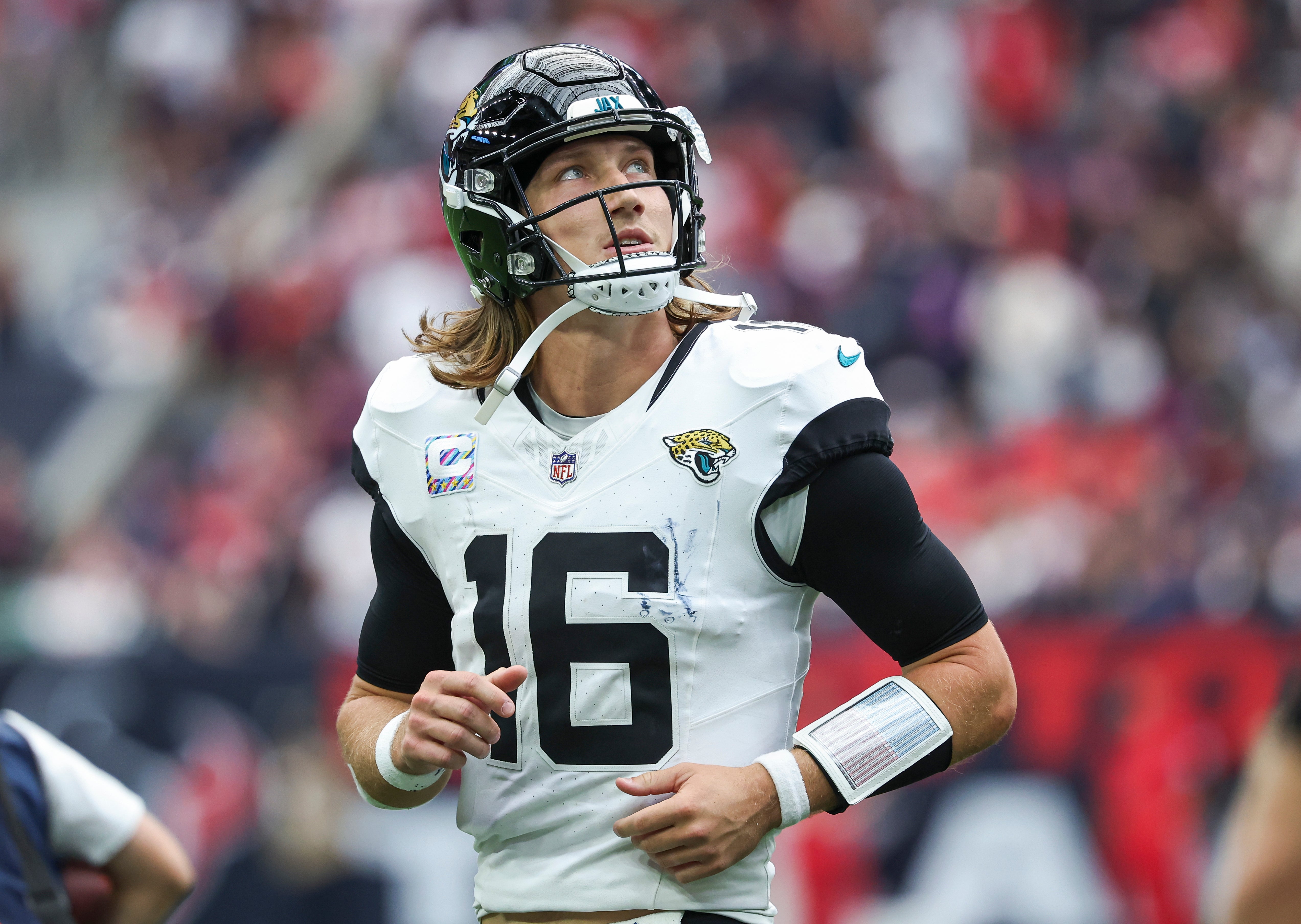 Sep 29, 2024; Houston, Texas, USA; Jacksonville Jaguars quarterback Trevor Lawrence (16) jogs off the field after a play during the fourth quarter against the Houston Texans at NRG Stadium.