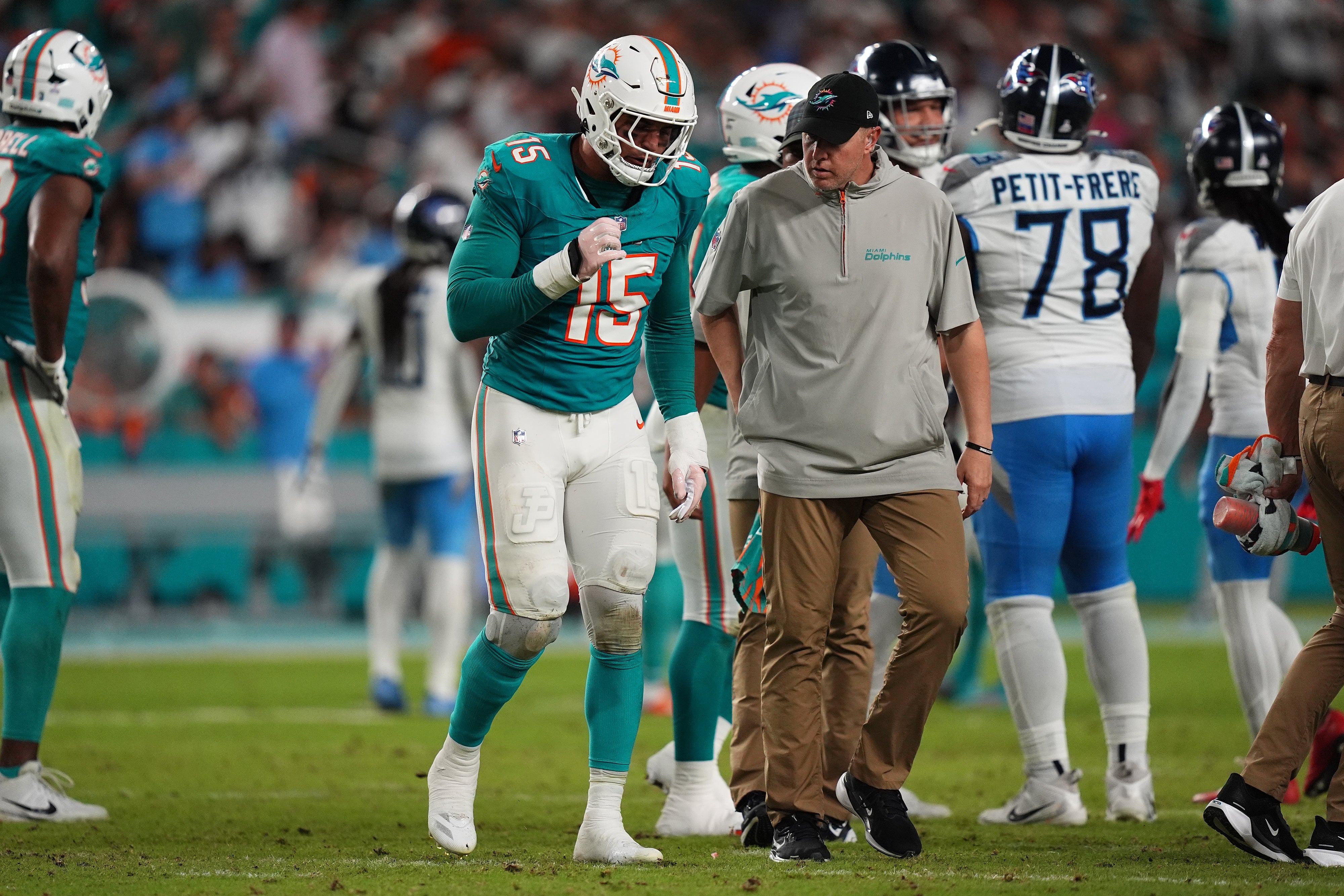Sep 30, 2024; Miami Gardens, Florida, USA; Miami Dolphins linebacker Jaelan Phillips (15) walks off the field with a team trainer after an apparent injury during the second half against the Tennessee Titans at Hard Rock Stadium.