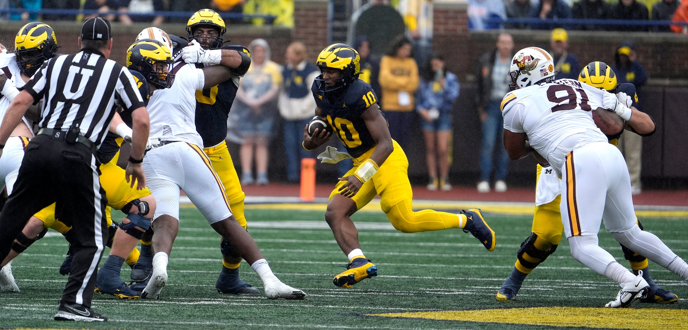Michigan quarterback Alex Orji runs out of the pocket during first-half action between Michigan and Minnesota at Michigan Stadium in Ann Arbor on Saturday, Sept. 28, 2024.