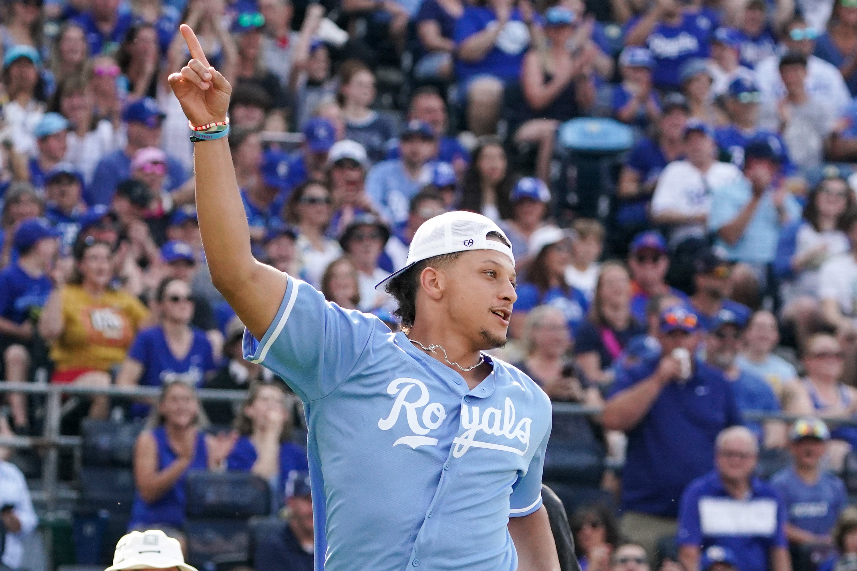 Jun 2, 2023; Kansas City, Missouri, USA; Kansas City Chiefs quarterback Patrick Mahomes celebrates after scoring during the annual Big Slick celebrity softball game prior to a game between the Kansas City Royals and Colorado Rockies at Kauffman Stadium.