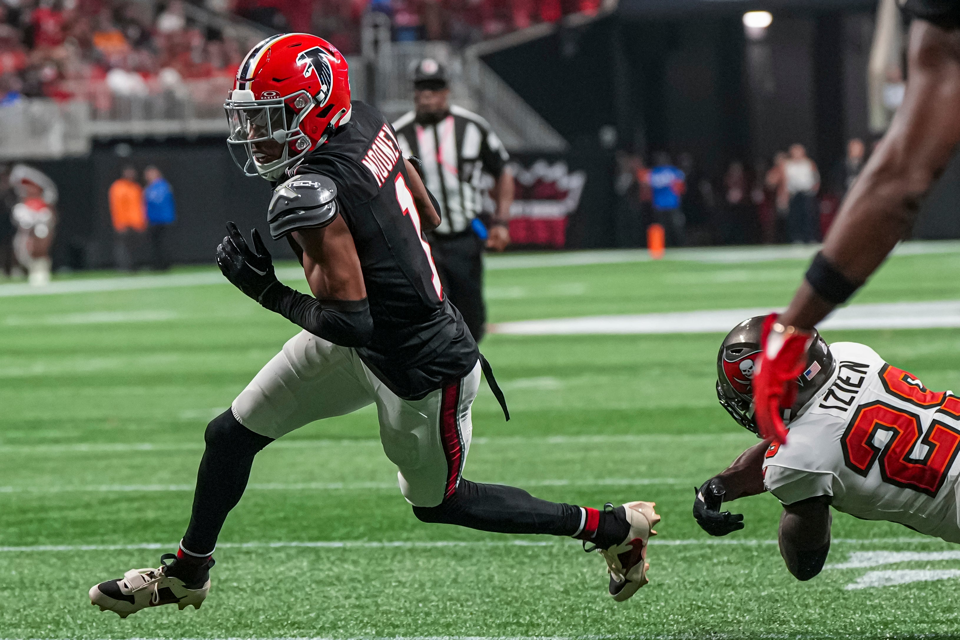 Oct 3, 2024; Atlanta, Georgia, USA; Atlanta Falcons wide receiver Darnell Mooney (1) breaks a tackle by Tampa Bay Buccaneers safety Christian Izien (29) on his way to a touchdown during the second half at Mercedes-Benz Stadium.