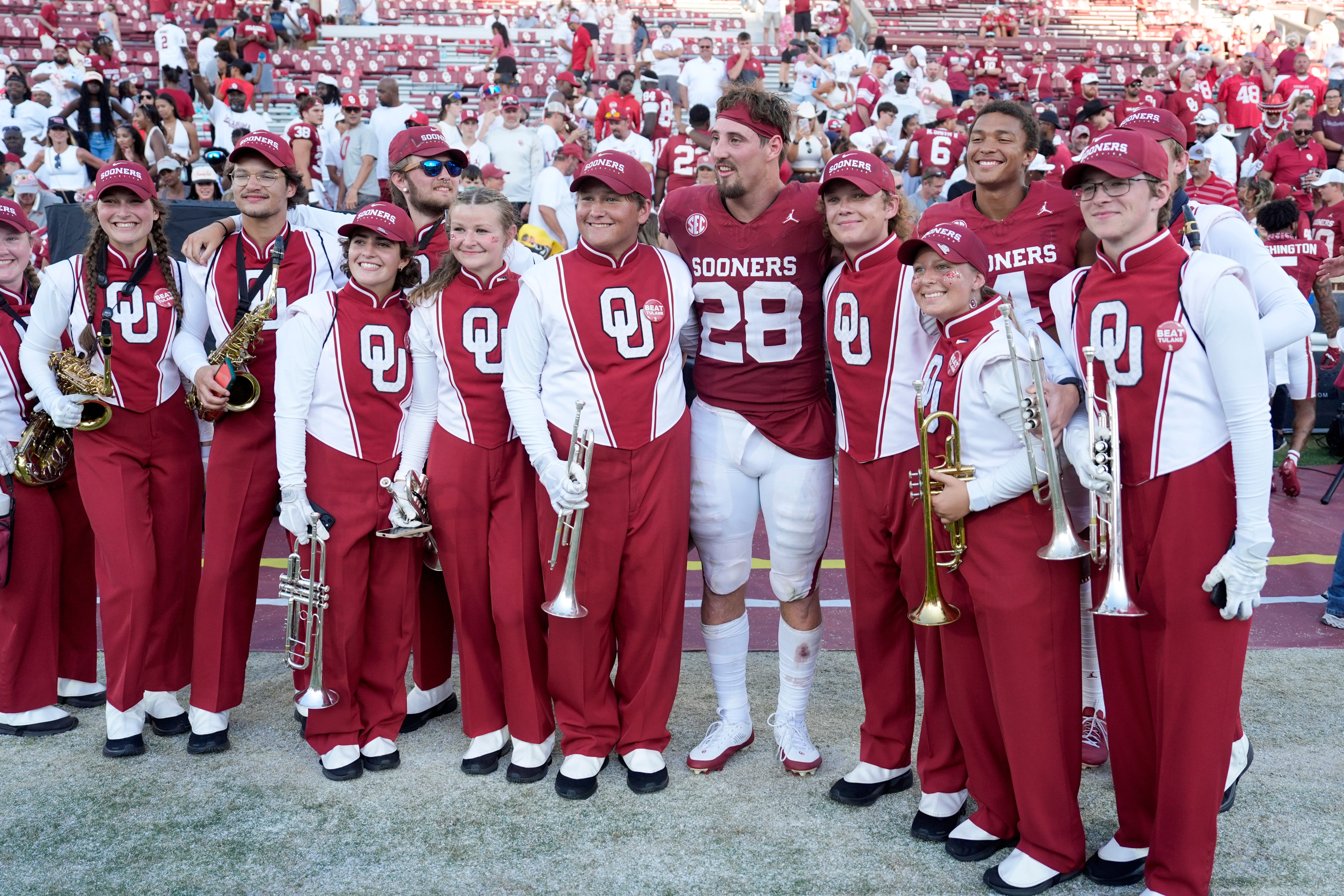Oklahoma Sooners linebacker Danny Stutsman (28) poses for a photo with members of the Pride of Oklahoma marching band after a college football game between the University of Oklahoma Sooners (OU) and the Tulane Green Wave at Gaylord Family - Oklahoma Memorial Stadium in Norman, Okla., Saturday, Sept. 14, 2024.