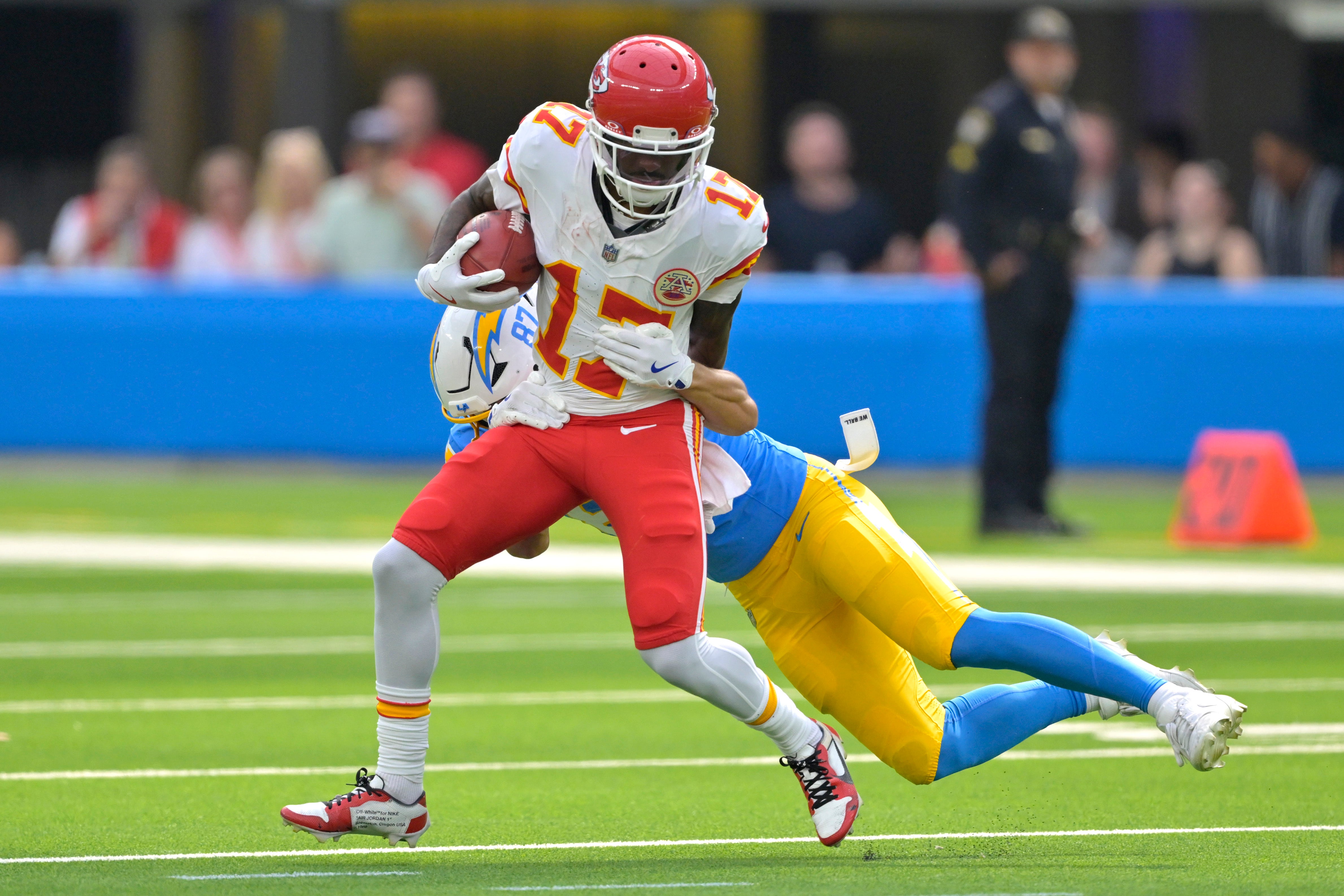 Sep 29, 2024; Inglewood, California, USA; Kansas City Chiefs wide receiver Mecole Hardman (17) is stopped by Los Angeles Chargers wide receiver Simi Fehoko (87) on a kick off return in the first half at SoFi Stadium.