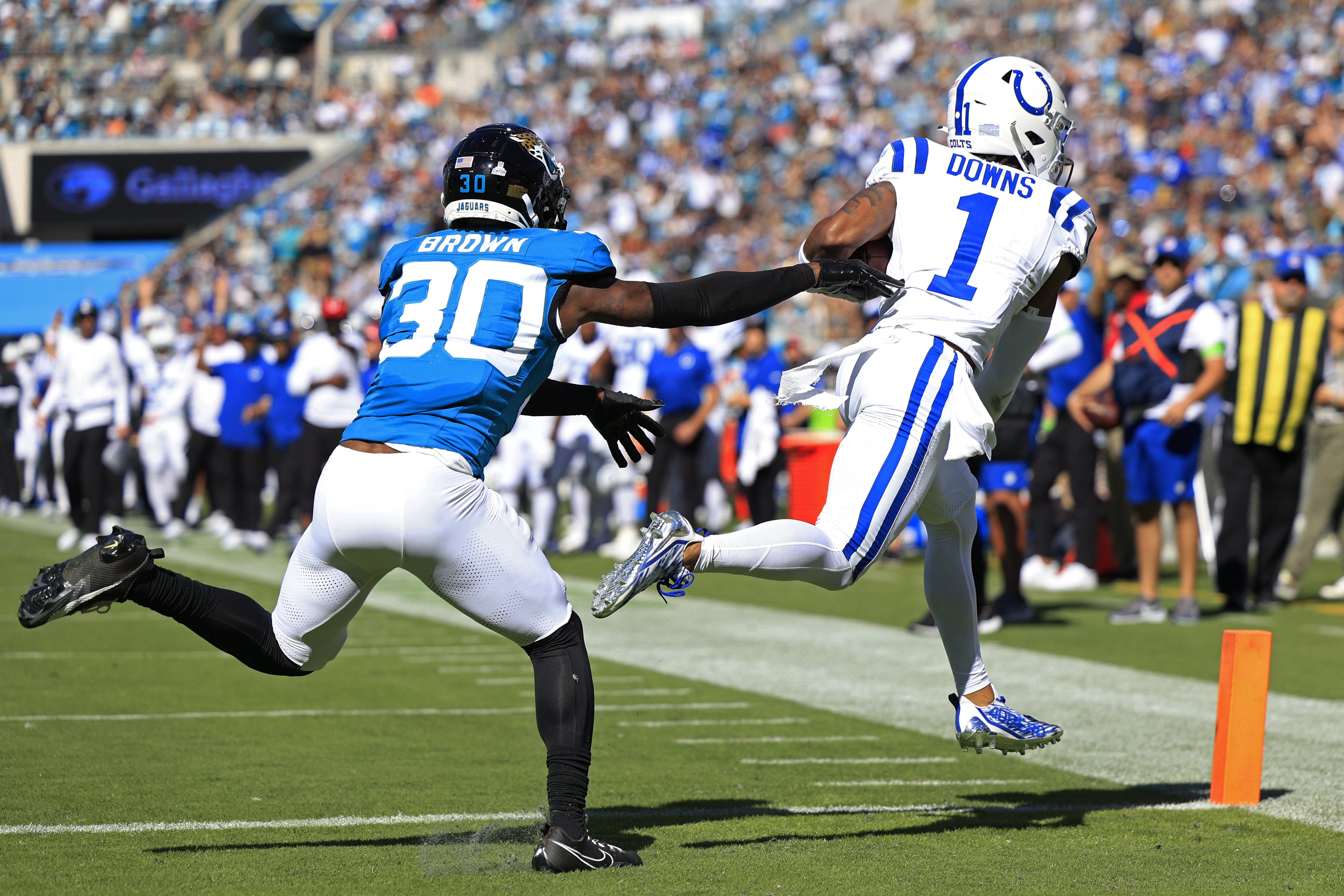 Indianapolis Colts wide receiver Josh Downs (1) scores a touchdown against Jacksonville Jaguars cornerback Montaric Brown (30) during the fourth quarter of an NFL football matchup Sunday, Oct. 15, 2023 at EverBank Stadium in Jacksonville, Fla. The Jacksonville Jaguars defeated the Indianapolis Colts 37-20.
