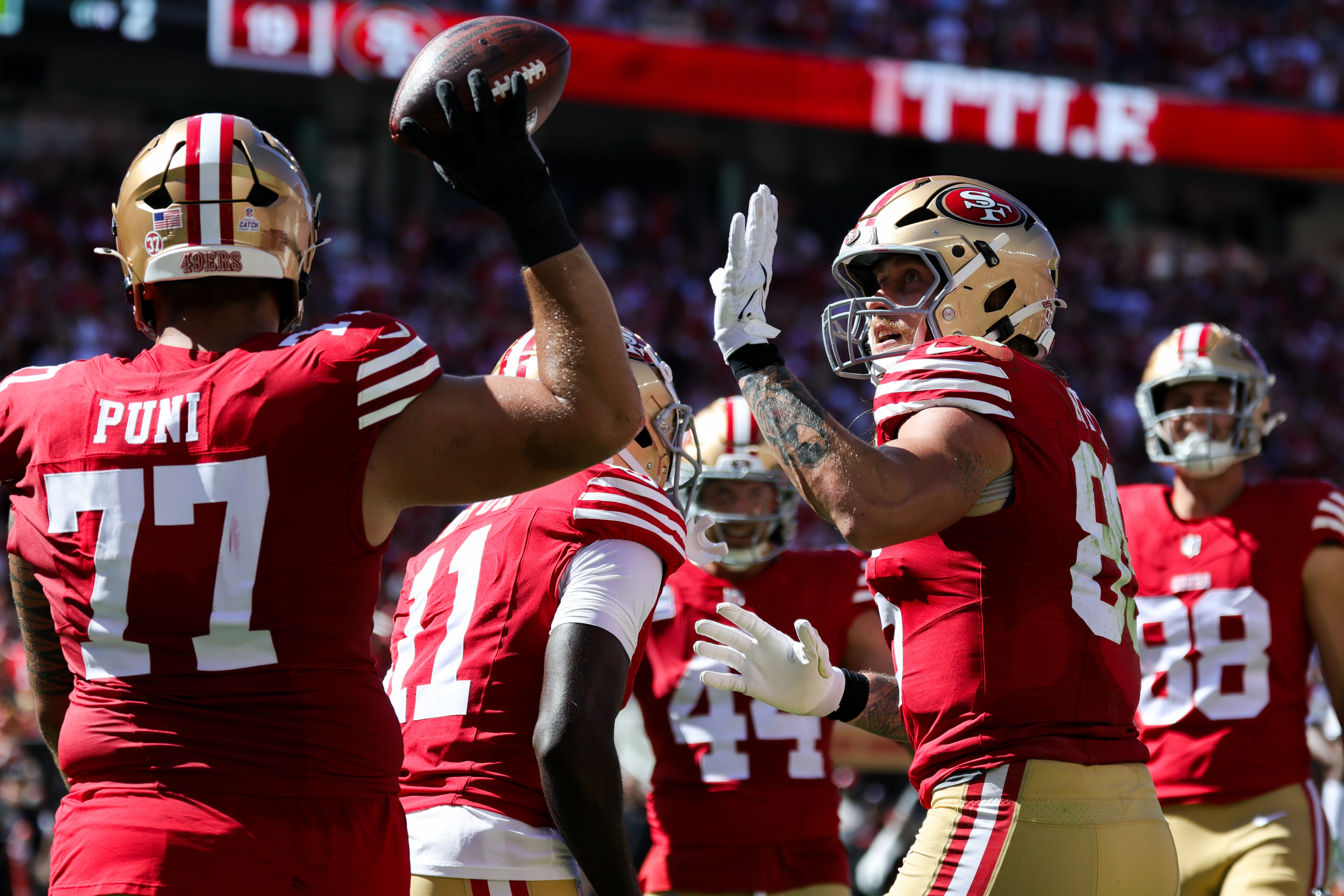 San Francisco 49ers tight end George Kittle (85) celebrates with teammates after a touchdown against the New England Patriots during the second quarter at Levi's Stadium.