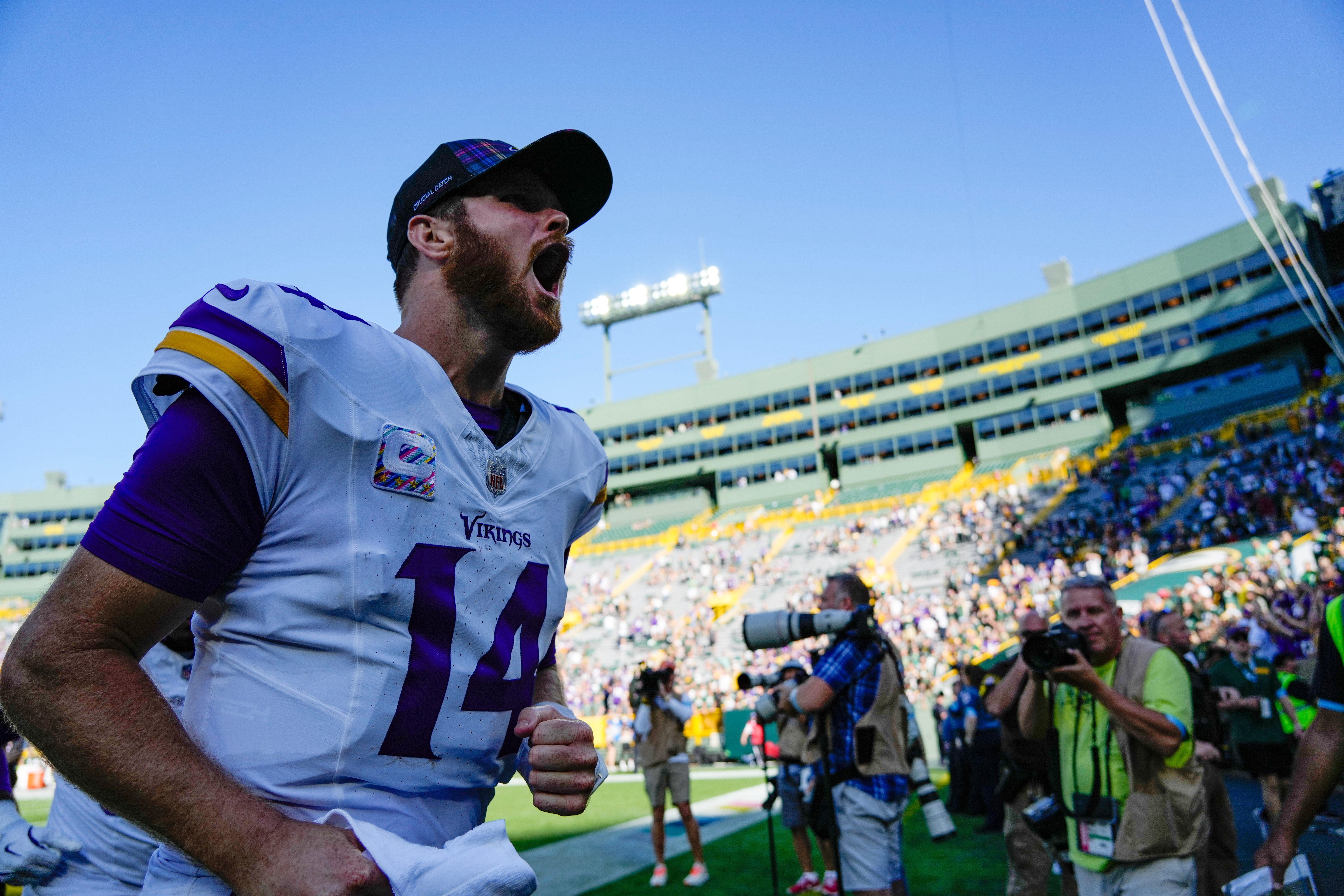 Sep 29, 2024; Green Bay, Wisconsin, USA; Minnesota Vikings quarterback Sam Darnold (14) cheers as he leaves the field following the game against the Green Bay Packers at Lambeau Field.
