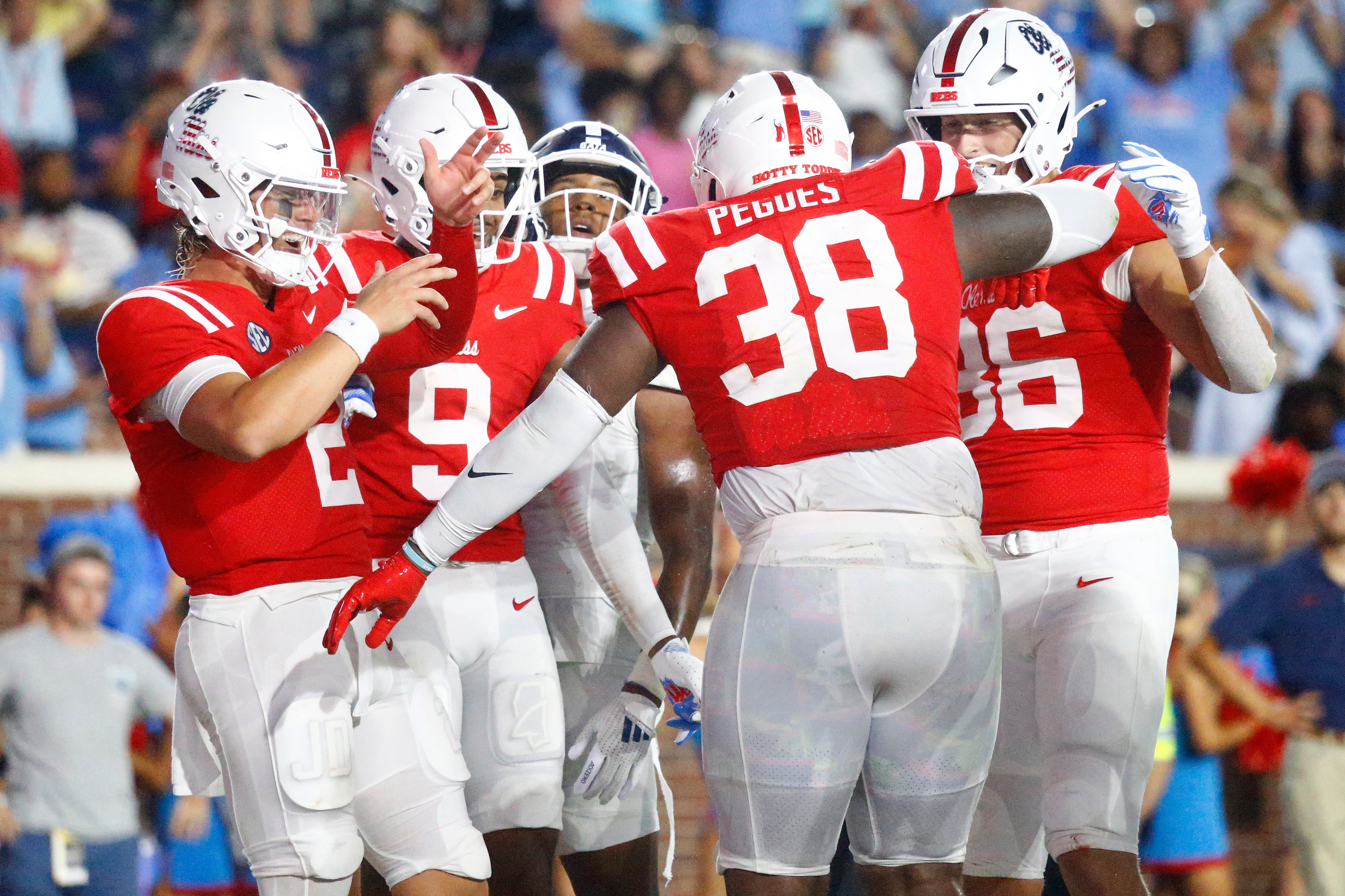 Sep 21, 2024; Oxford, Mississippi, USA; Mississippi Rebels quarterback Jaxson Dart (2), wide receiver Tre Harris (9) and tight end Caden Prieskorn (86) react with defensive linemen JJ Pegues (38) after a touchdown during the second half against the Georgia Southern Eagles at Vaught-Hemingway Stadium.