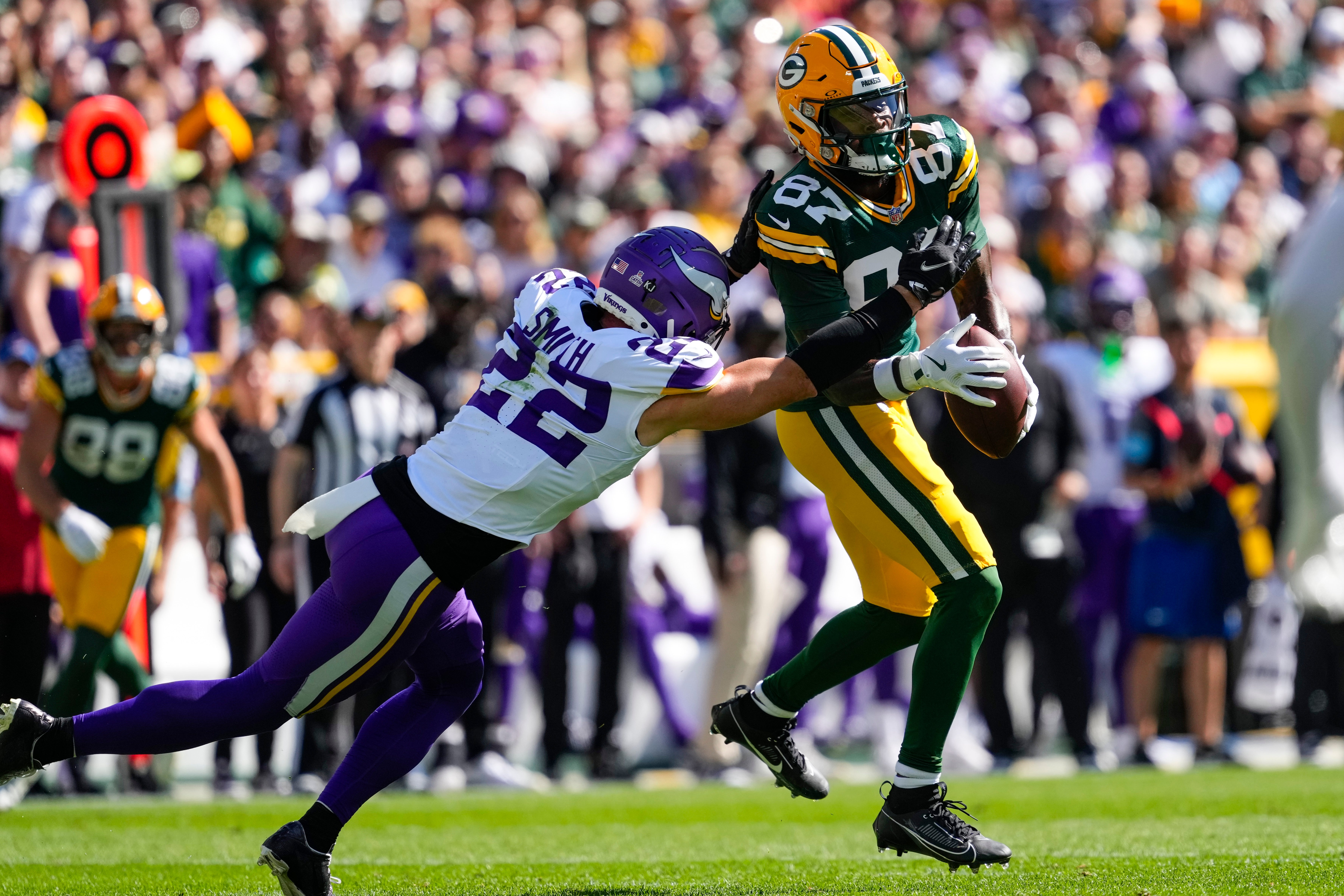 Minnesota Vikings safety Harrison Smith (22) breaks up the pass intended for Green Bay Packers wide receiver Romeo Doubs (87) during the second quarter at Lambeau Field.