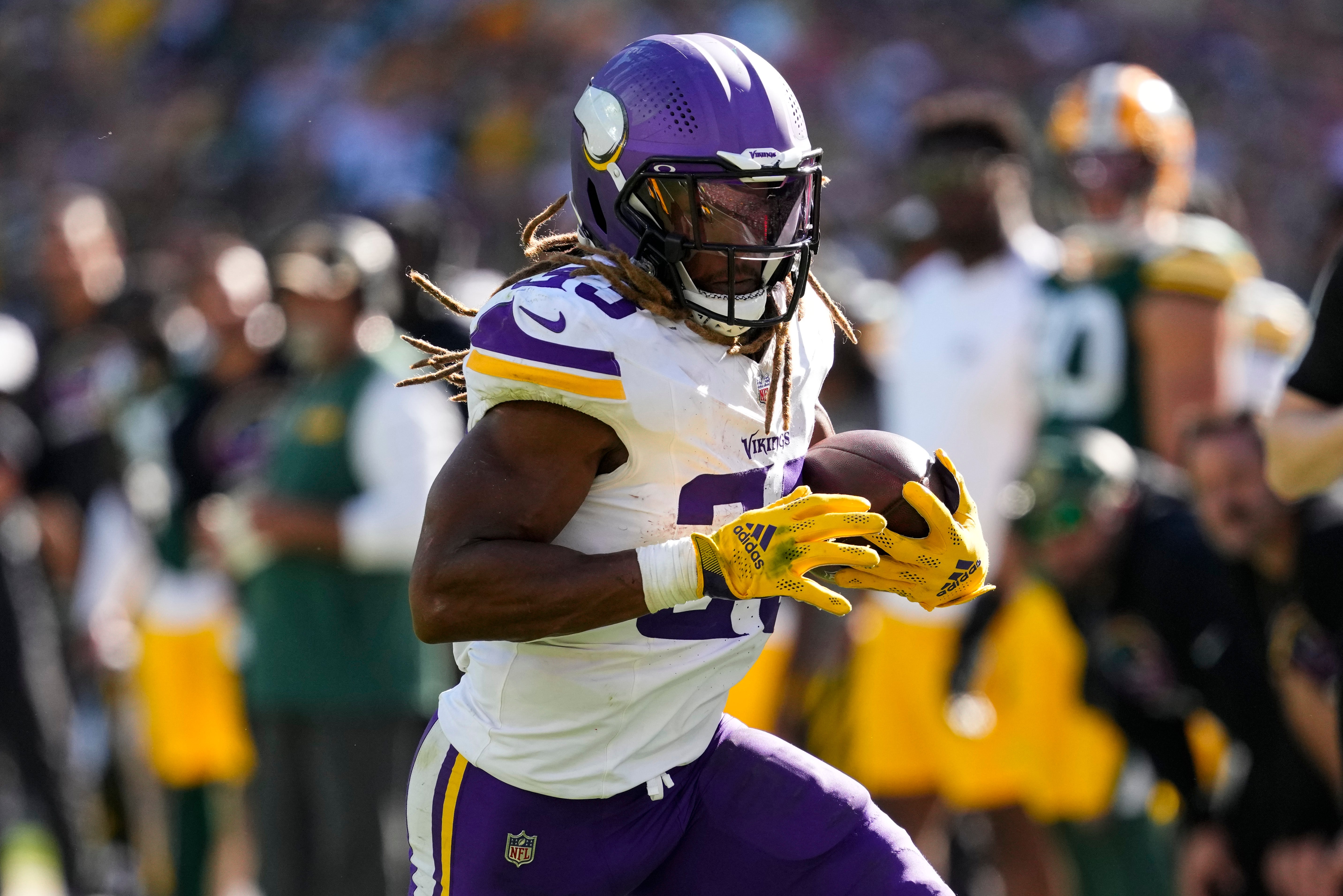 Sep 29, 2024; Green Bay, Wisconsin, USA; Minnesota Vikings running back Aaron Jones (33) rushes with the football during the fourth quarter against the Green Bay Packers at Lambeau Field.