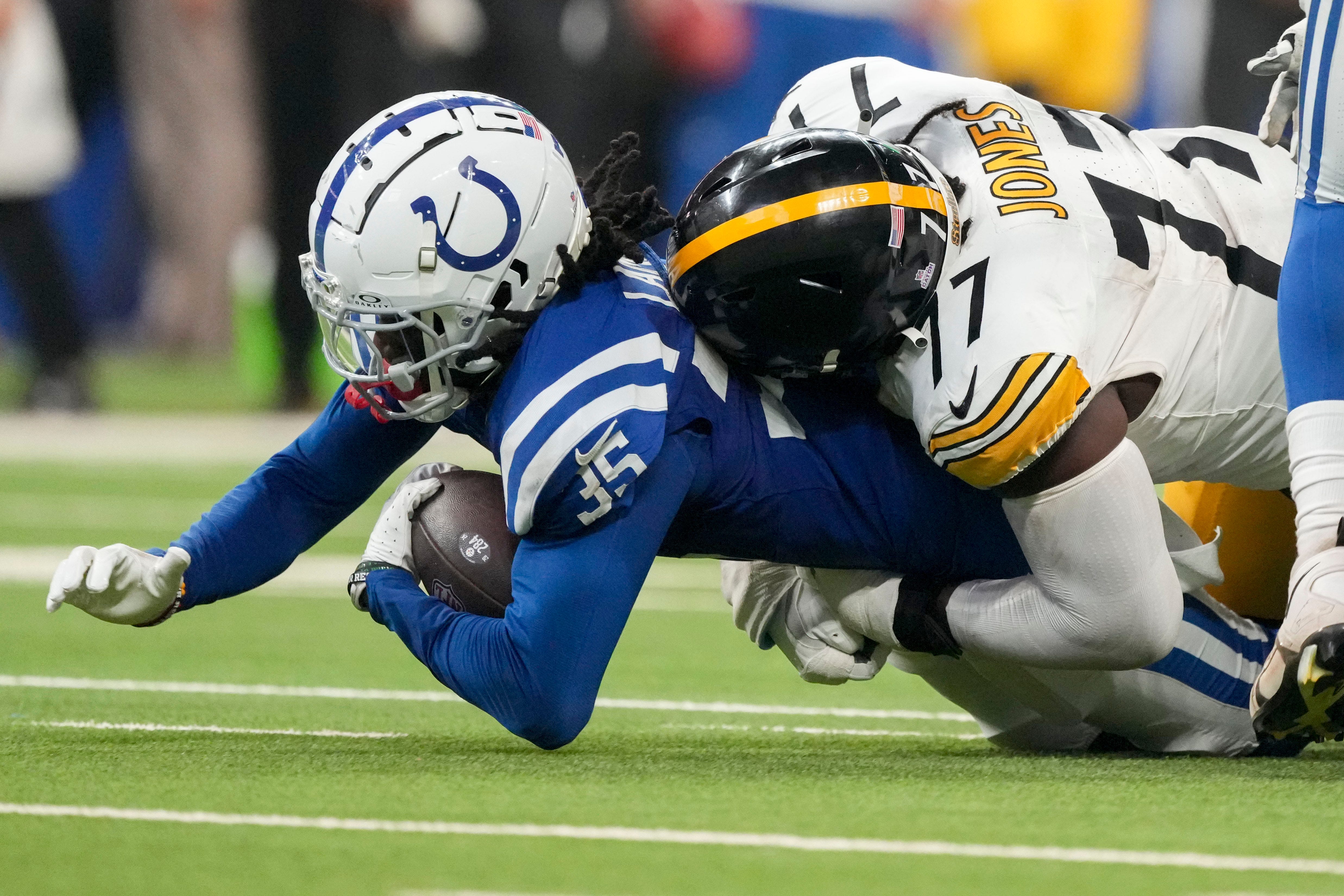 Indianapolis Colts cornerback Chris Lammons (35) is tackled by Pittsburgh Steelers offensive tackle Broderick Jones (77) after recovering a fumble Sunday, Sept. 29, 2024, during a game against the Pittsburgh Steelers at Lucas Oil Stadium in Indianapolis.