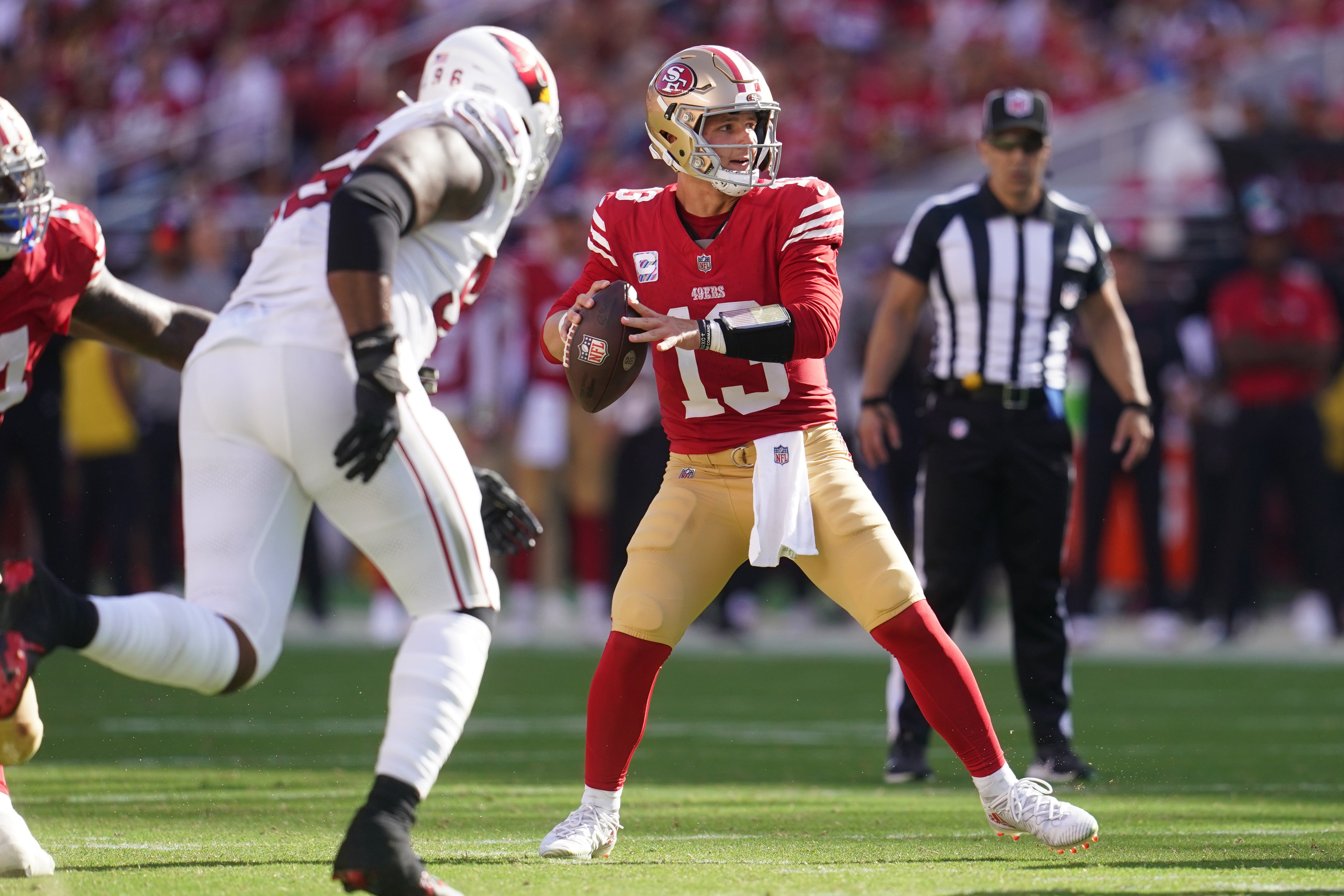 San Francisco 49ers quarterback Brock Purdy (13) looks to throw a pass against the Arizona Cardinals in the fourth quarter at Levi's Stadium.