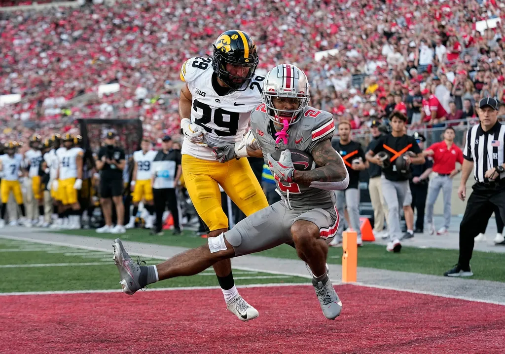Ohio State Buckeyes wide receiver Emeka Egbuka (2) makes a touchdown catch against Iowa Hawkeyes defensive back Sebastian Castro (29) in the fourth quarter during the NCAA football game at Ohio Stadium