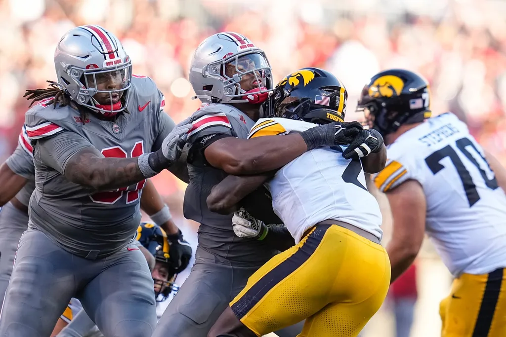 Ohio State Buckeyes safety Sonny Styles (6) tackles Iowa Hawkeyes running back Kaleb Johnson (2) during the second half of the NCAA football game at Ohio Stadium. Ohio State won 35-7