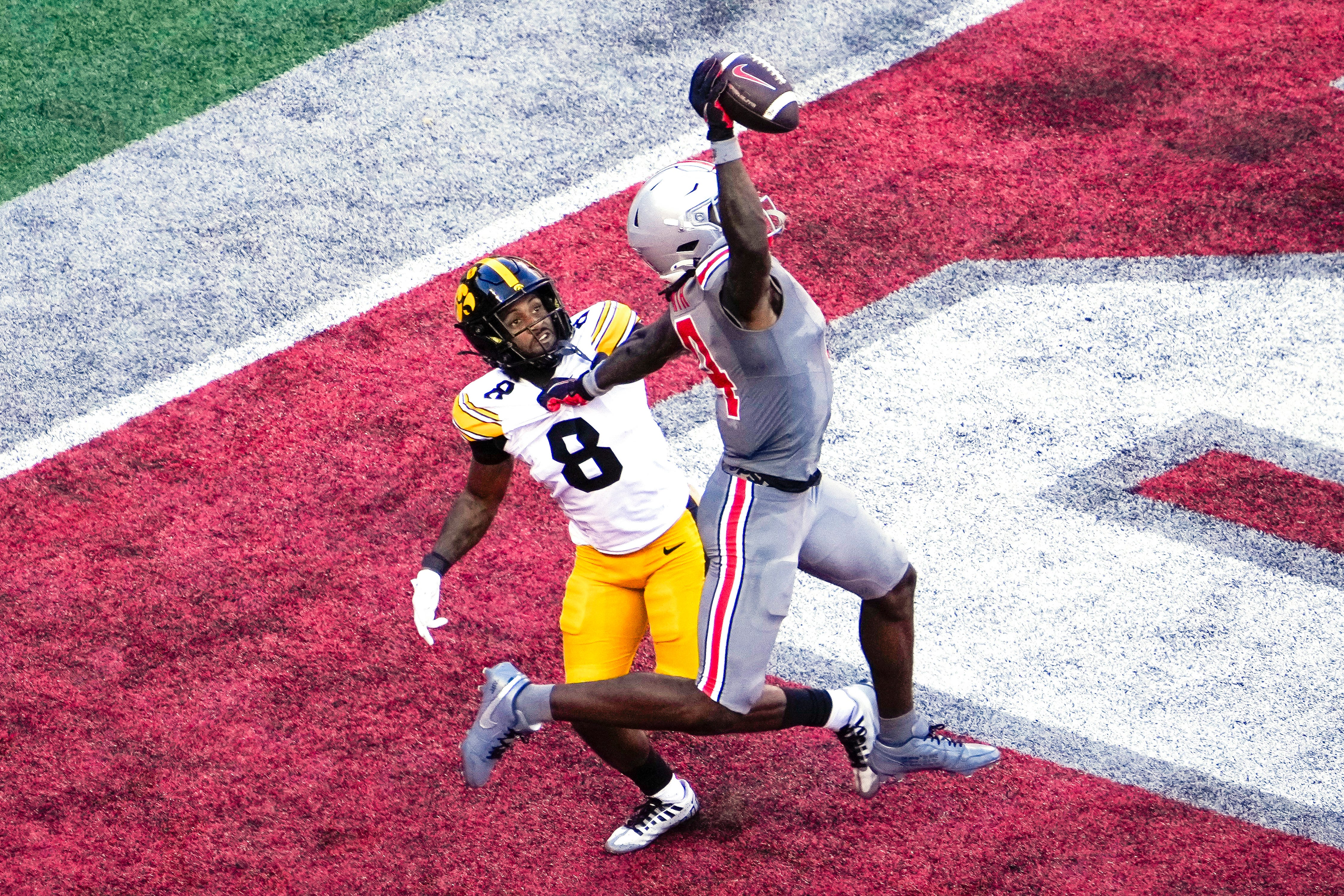 Oct 5, 2024; Columbus, Ohio, USA; Ohio State Buckeyes wide receiver Jeremiah Smith (4) makes a one-handed touchdown catch against Iowa Hawkeyes defensive back Deshaun Lee (8) in the third quarter at Ohio Stadium on Saturday.