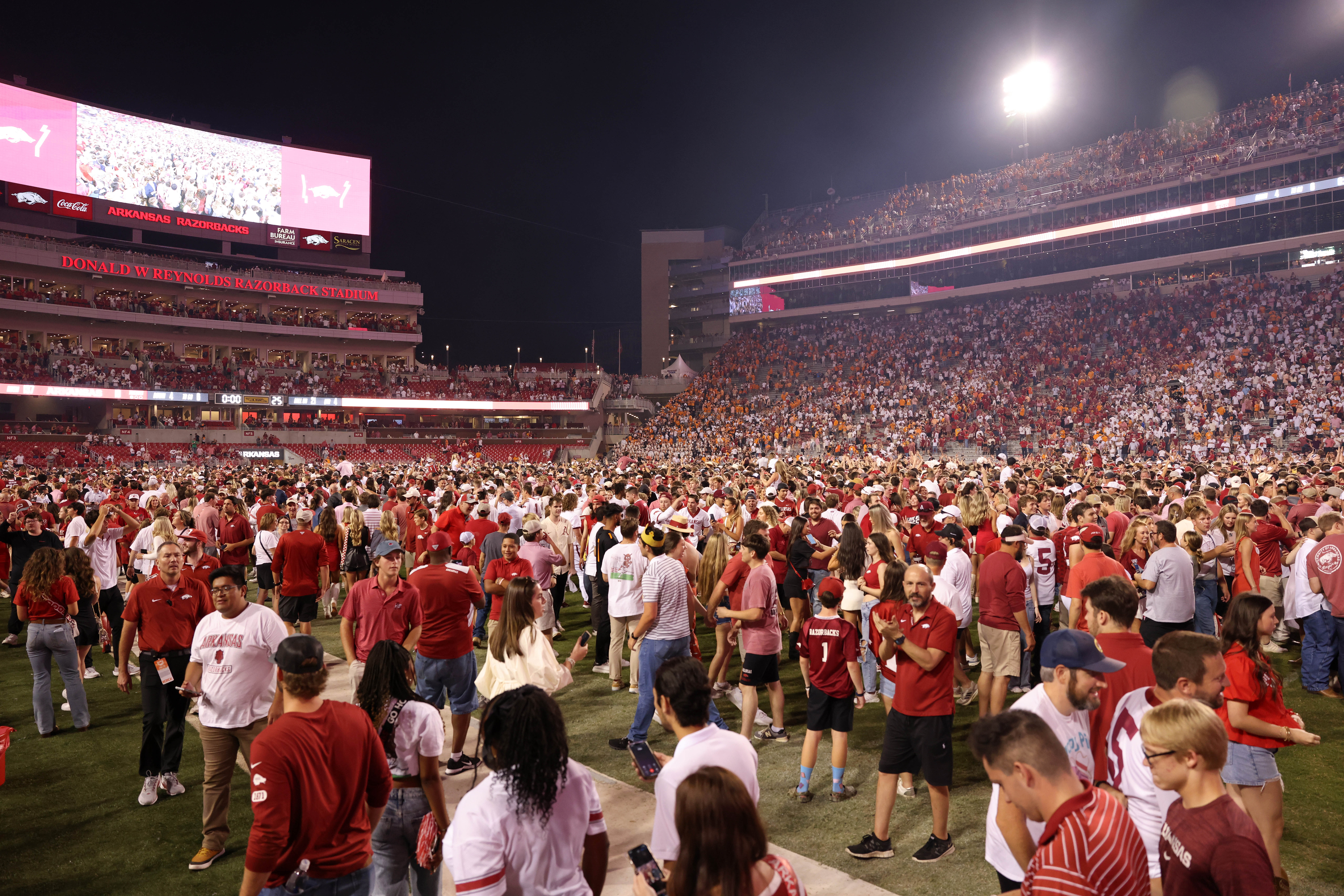 Oct 5, 2024; Fayetteville, Arkansas, USA; Arkansas Razorbacks fans flood the field after the game against the Tennessee Volunteers at Donald W. Reynolds Razorback Stadium. Arkansas won 19-14.