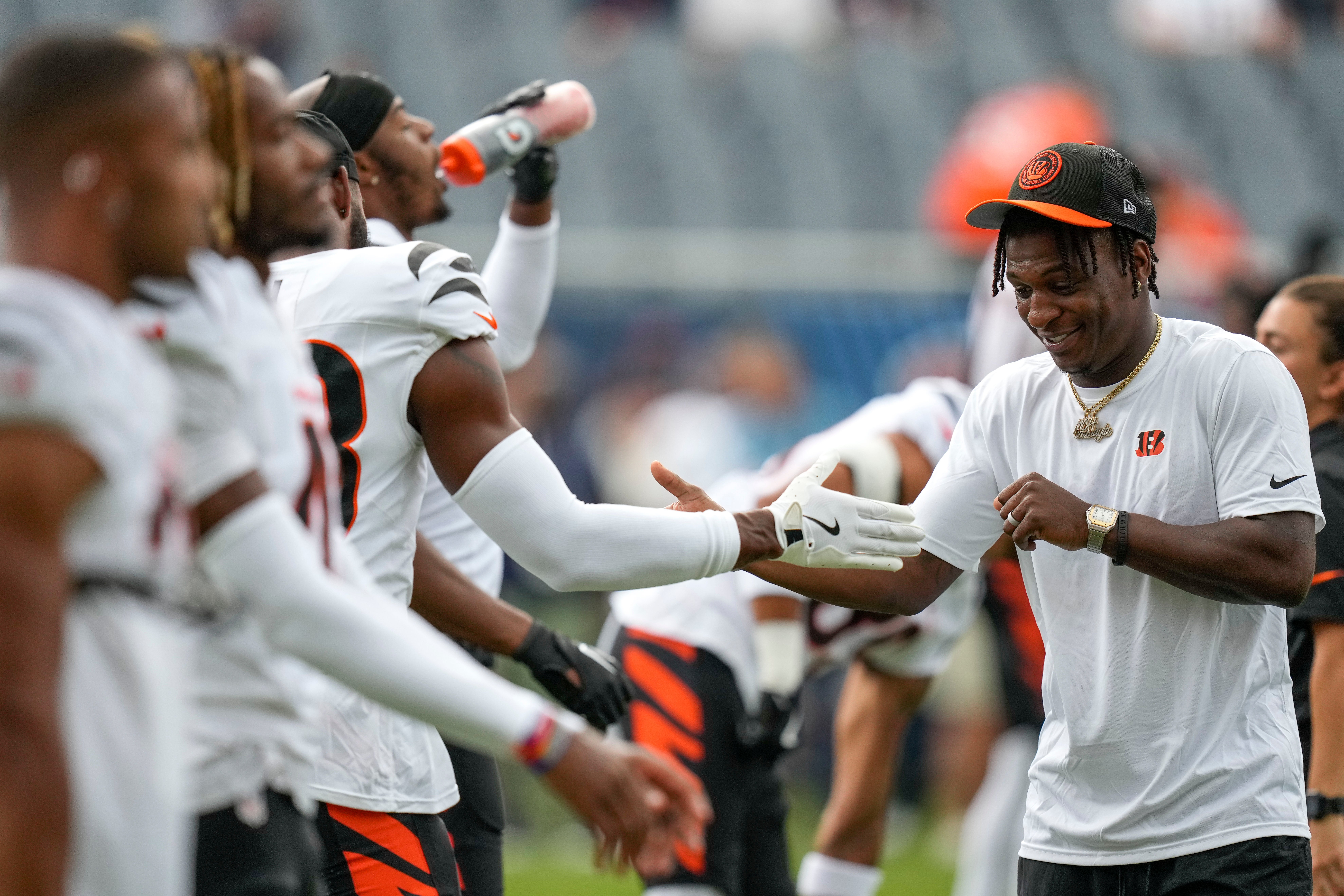 Aug 17, 2024; Chicago, Illinois, USA; Cincinnati Bengals cornerback Mike Hilton greets his teammates during warmups before the NFL Preseason Week 2 game between the Chicago Bears and the Cincinnati Bengals at Soldier Field.