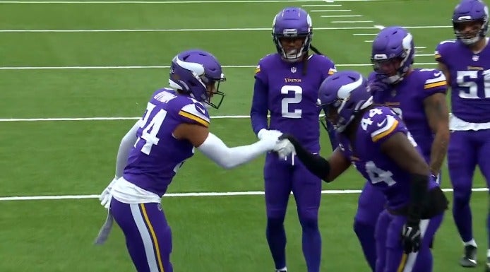Minnesota Vikings safeties Camryn Bynum (24) and Josh Metellus (44) celebrate Bynum's interception with the Parent Trap secret handshake made famous by Lindsay Lohan.