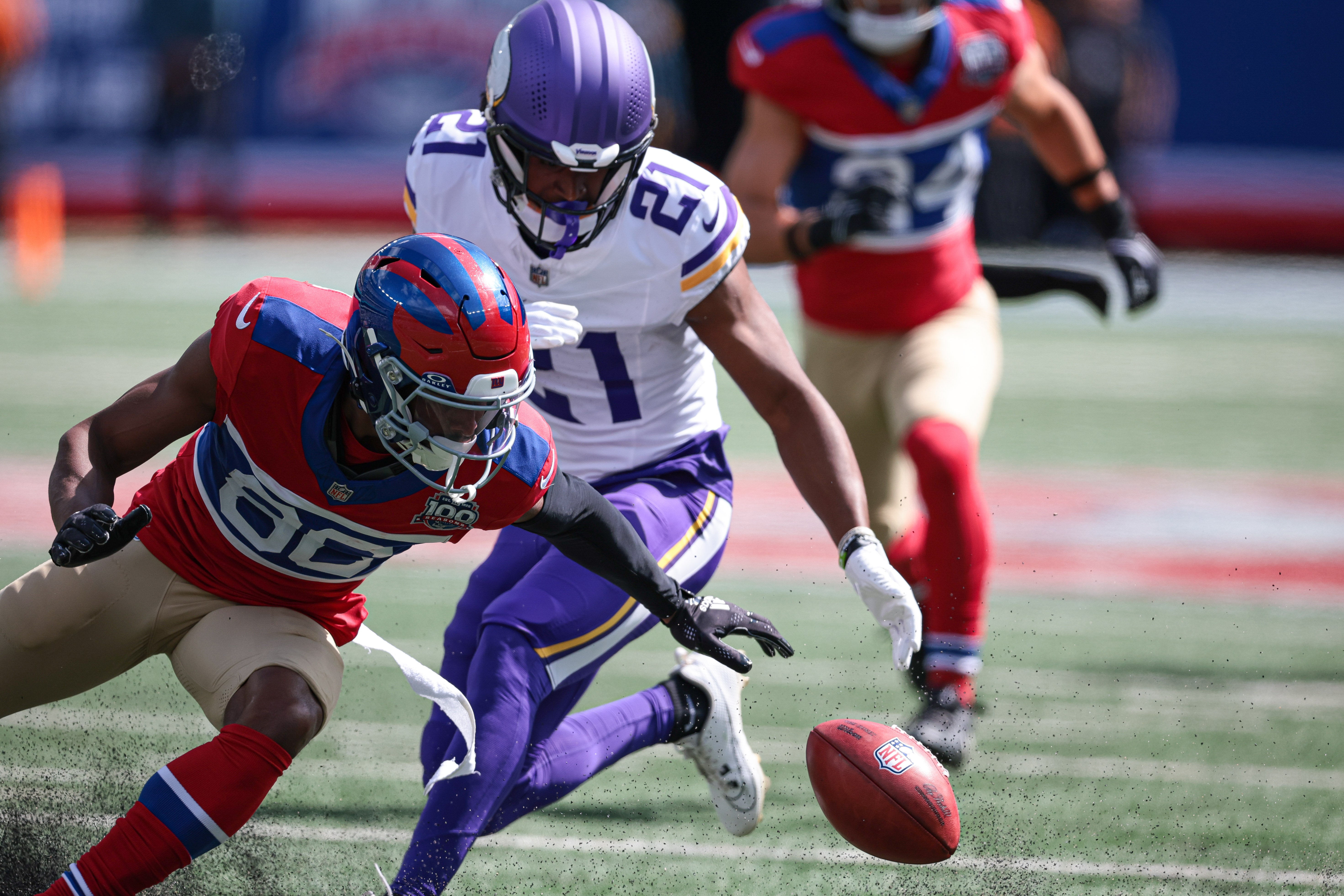 Sep 8, 2024; East Rutherford, New Jersey, USA; New York Giants wide receiver Darius Slayton (86) fumbles a punt during the first half in front of Minnesota Vikings cornerback Akayleb Evans (21) at MetLife Stadium.