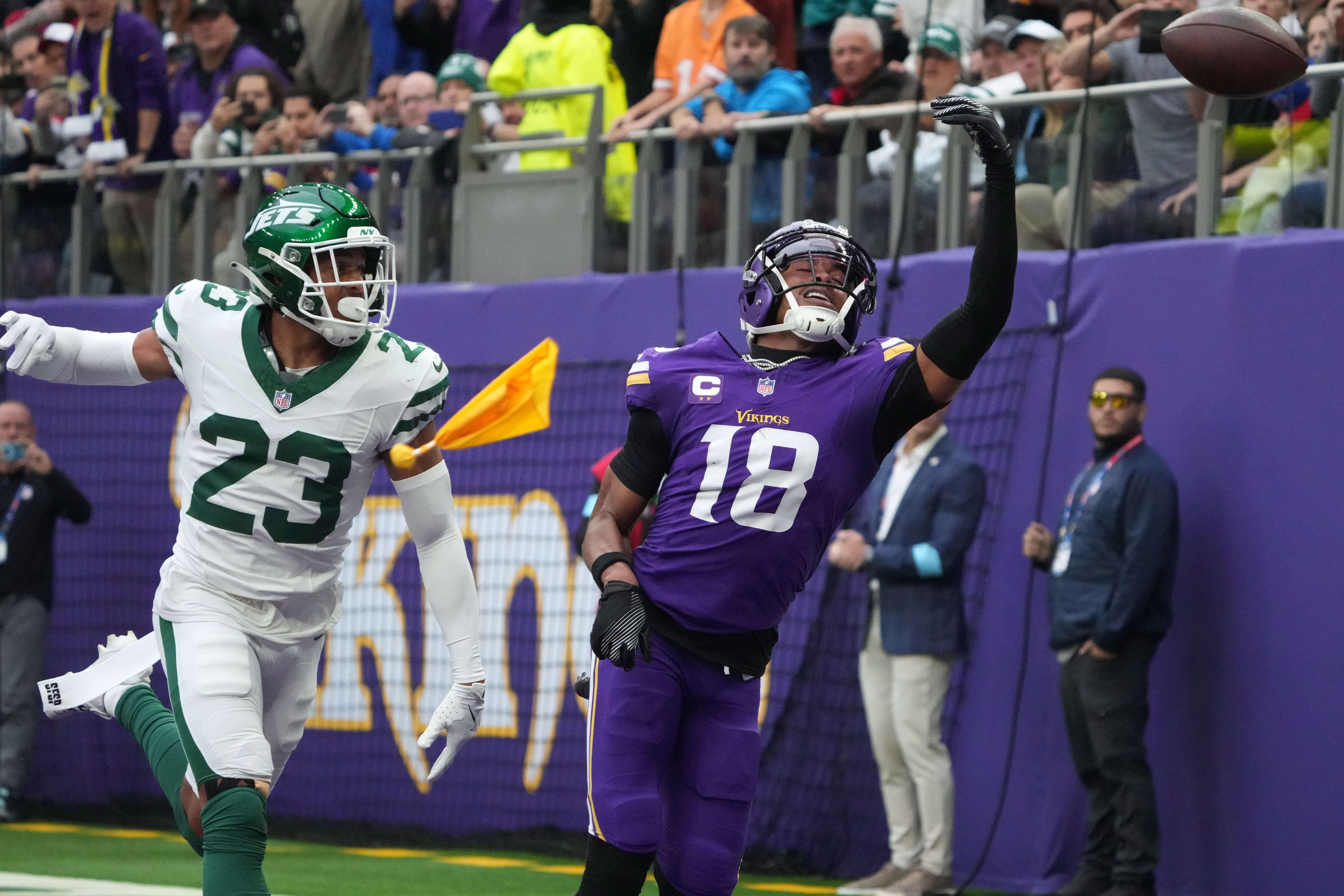 Oct 6, 2024; London, United Kingdom; Minnesota Vikings wide receiver Justin Jefferson (18) attempts to catch the ball against New York Jets cornerback Isaiah Oliver (23) in the first half at Tottenham Hotspur Stadium.