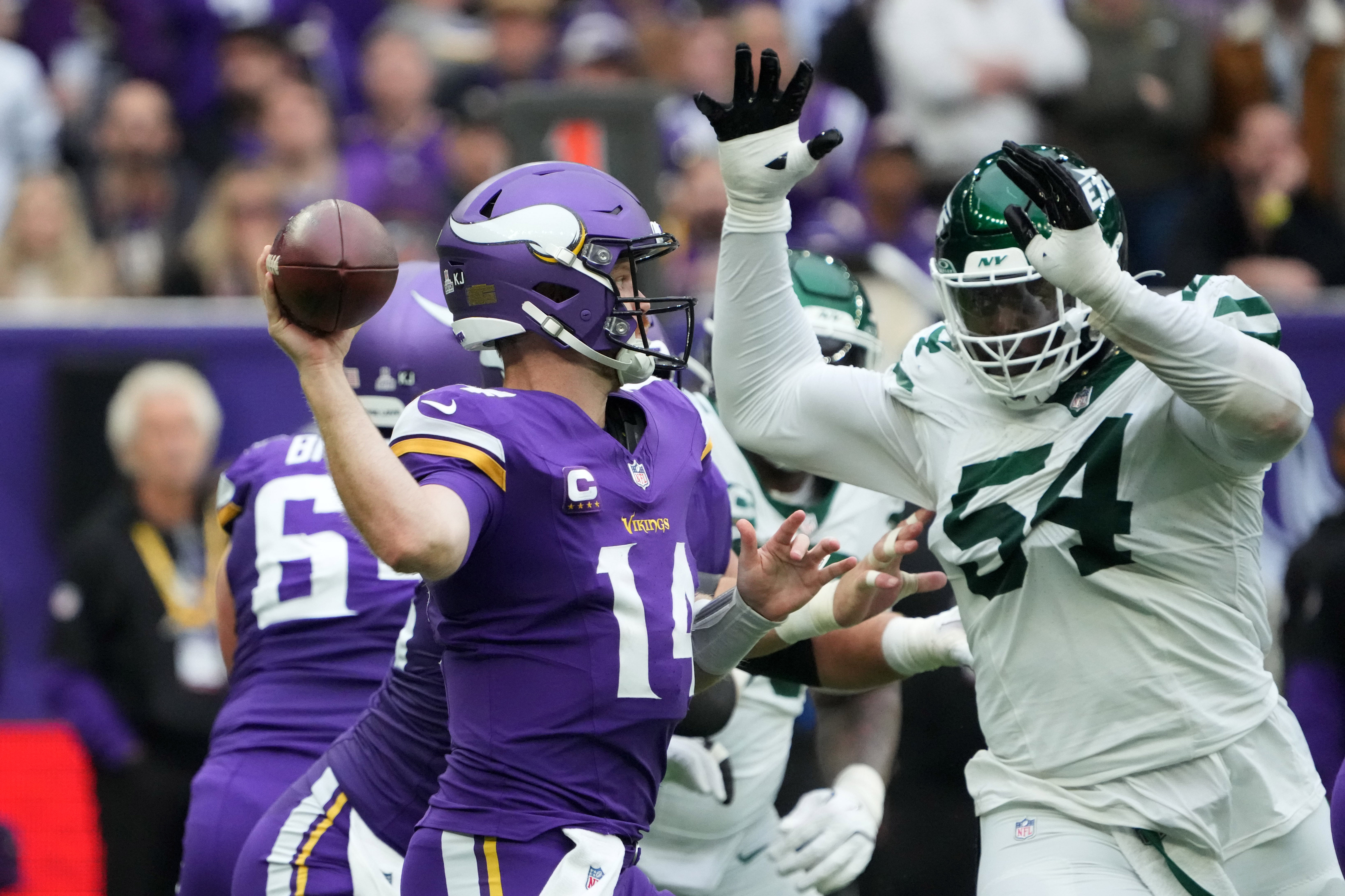 Oct 6, 2024; London, United Kingdom; Minnesota Vikings quarterback Sam Darnold (14) throws the ball against New York Jets defensive tackle Javon Kinlaw (54) in the first half at Tottenham Hotspur Stadium.
