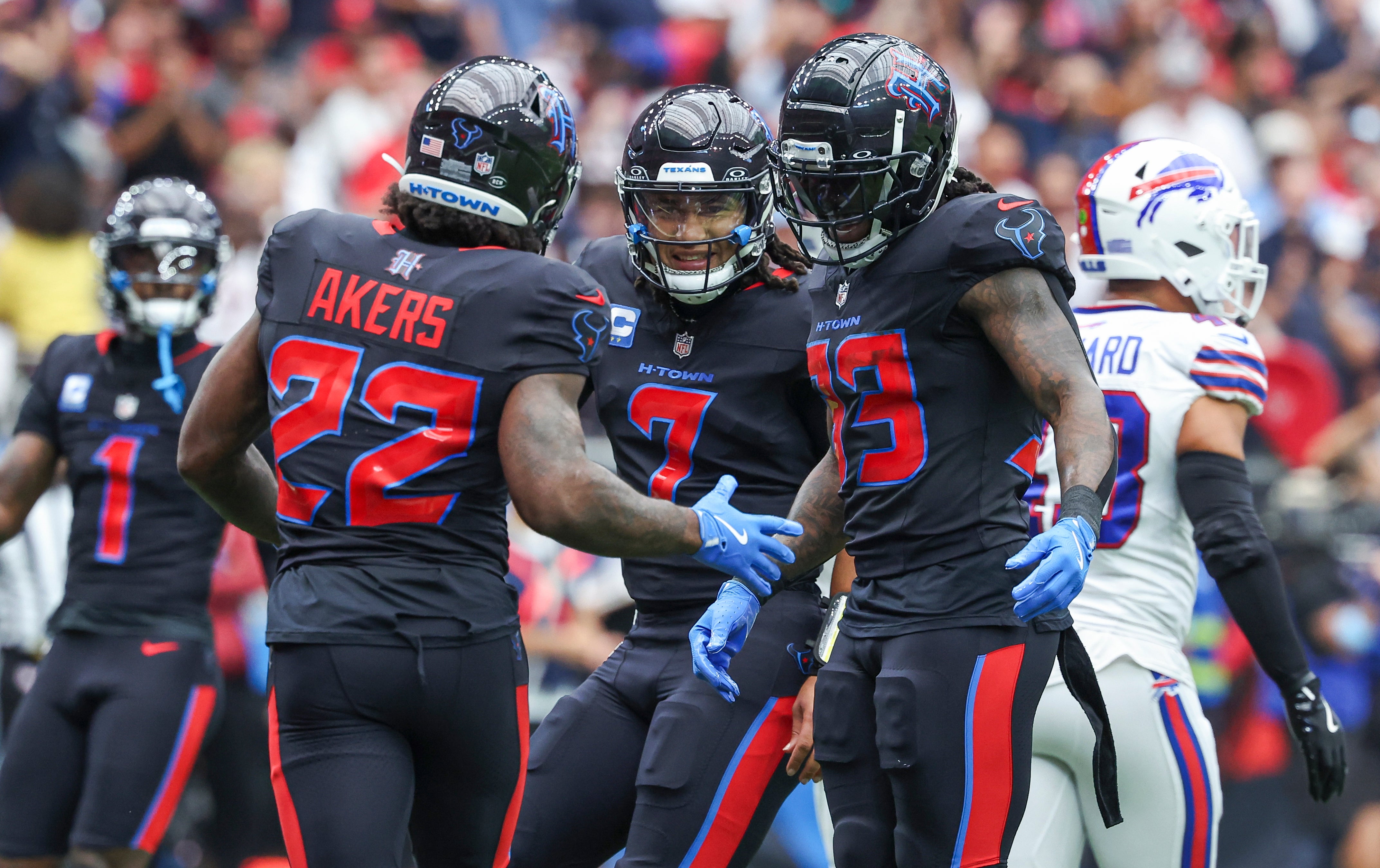 Houston Texans quarterback C.J. Stroud (7) celebrates with running back Cam Akers (22) after a touchdown during the first quarter against the Buffalo Bills at NRG Stadium. Troy Taormina-Imagn Images