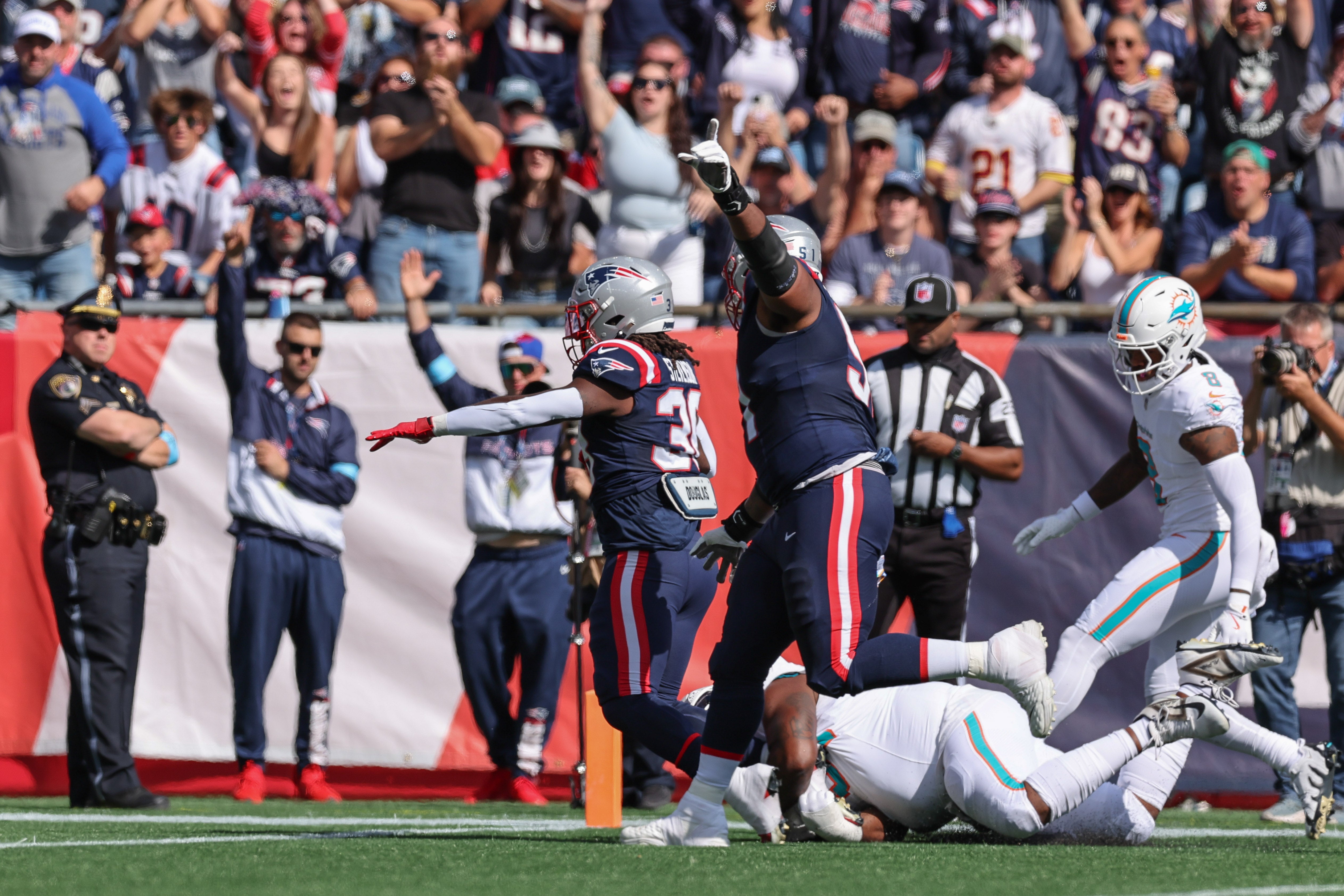 Oct 6, 2024; Foxborough, Massachusetts, USA; New England Patriots running back Rhamondre Stevenson (38) scores a touchdown during the first half against the Miami Dolphins at Gillette Stadium.