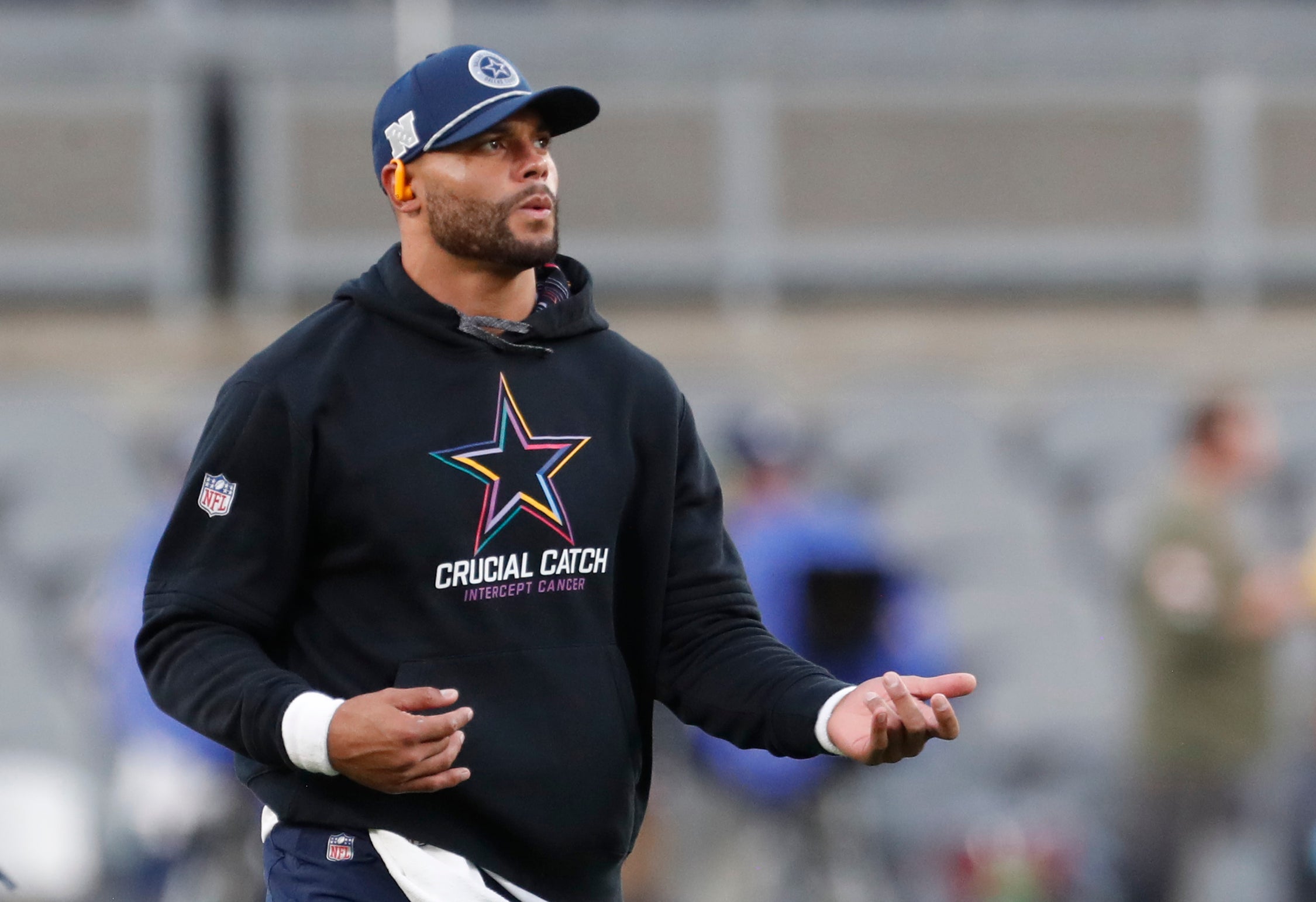 Dallas Cowboys quarterback Dak Prescott (4) plays air guitar during warm ups before the game against the Pittsburgh Steelers at Acrisure Stadium.