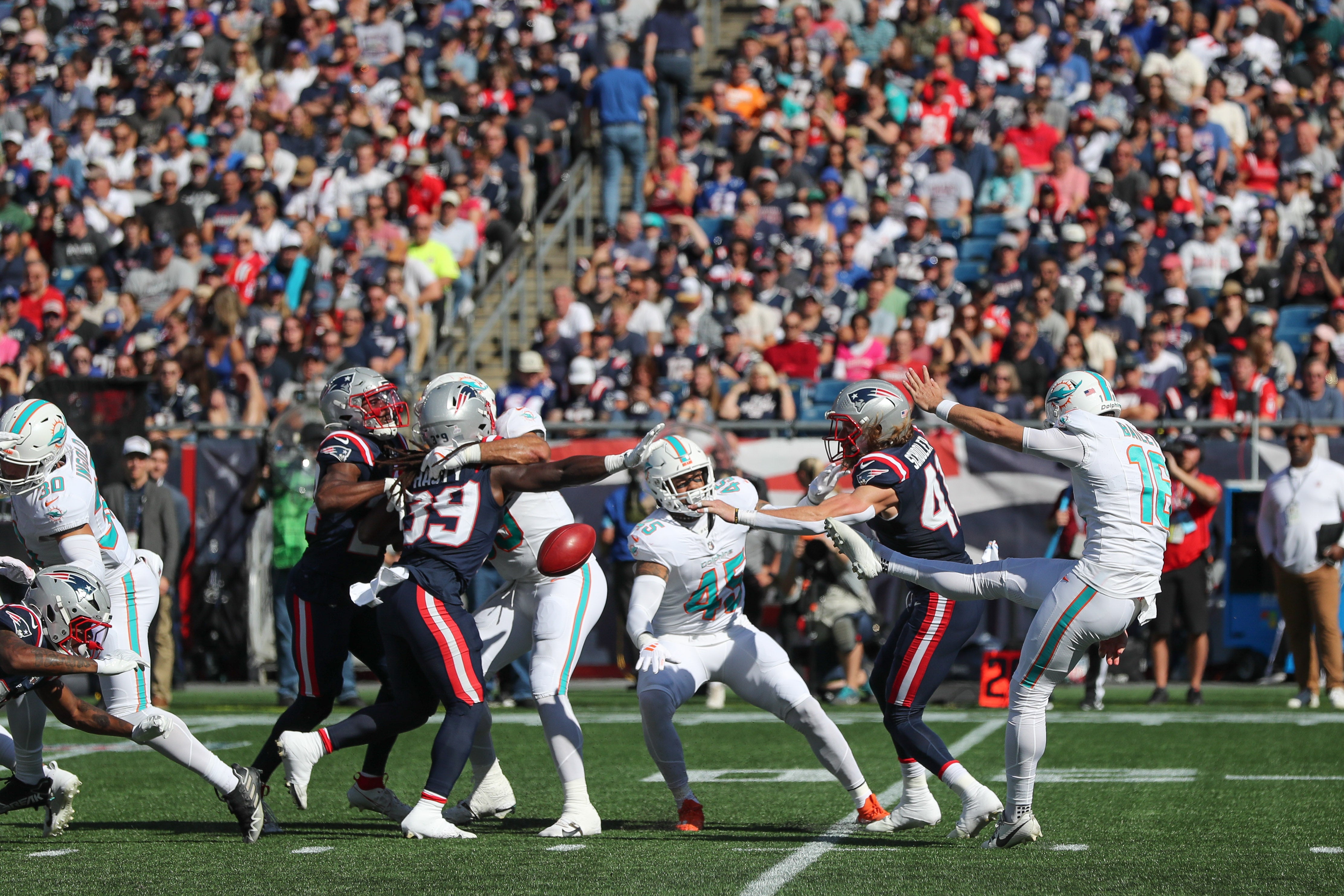 Oct 6, 2024; Foxborough, Massachusetts, USA; New England Patriots safety Brenden Schooler (41) blocks a punt by Miami Dolphins punter Jake Bailey (16) during the first half at Gillette Stadium.