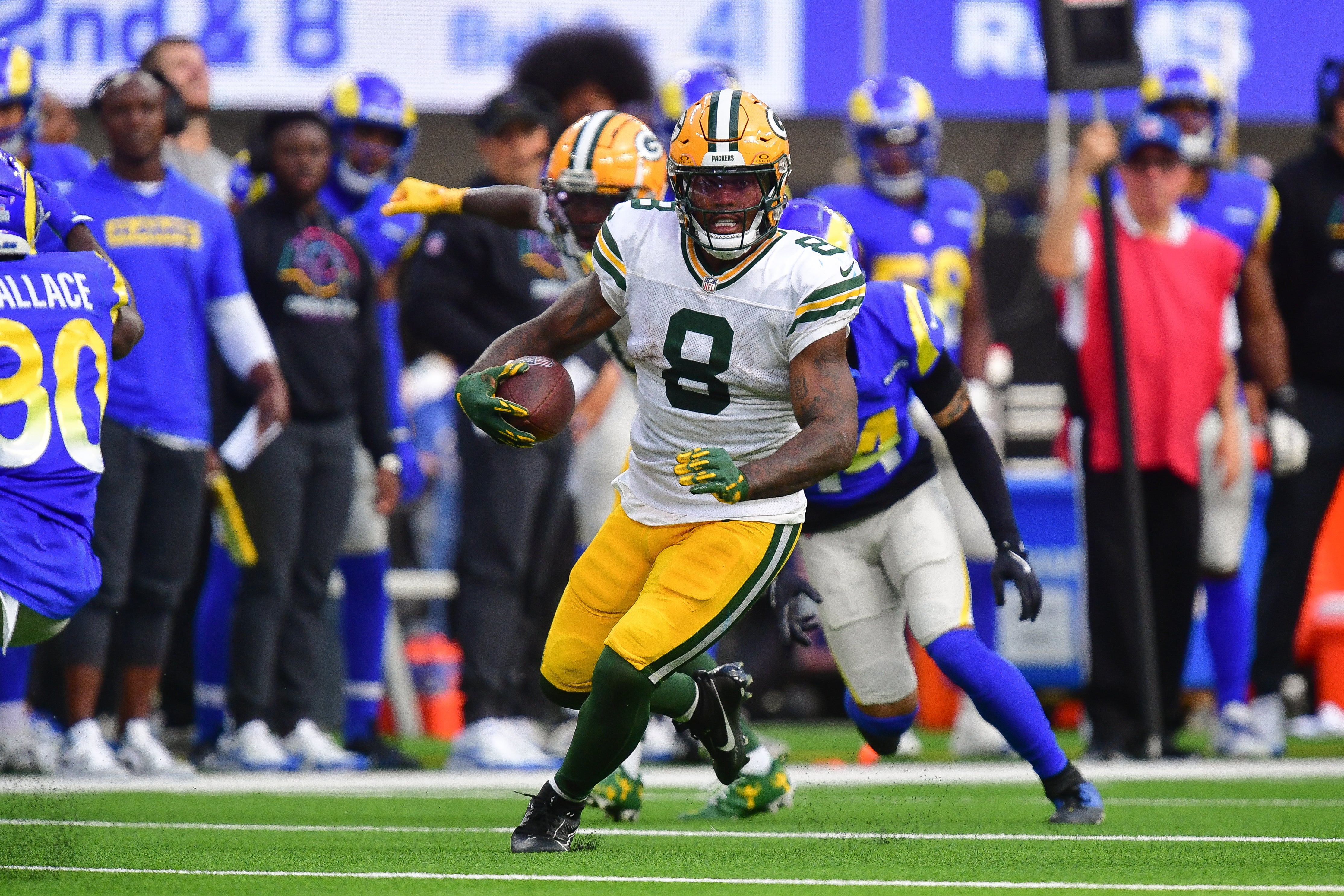 Green Bay Packers running back Josh Jacobs (8) runs the ball against the Los Angeles Rams during the second half at SoFi Stadium.