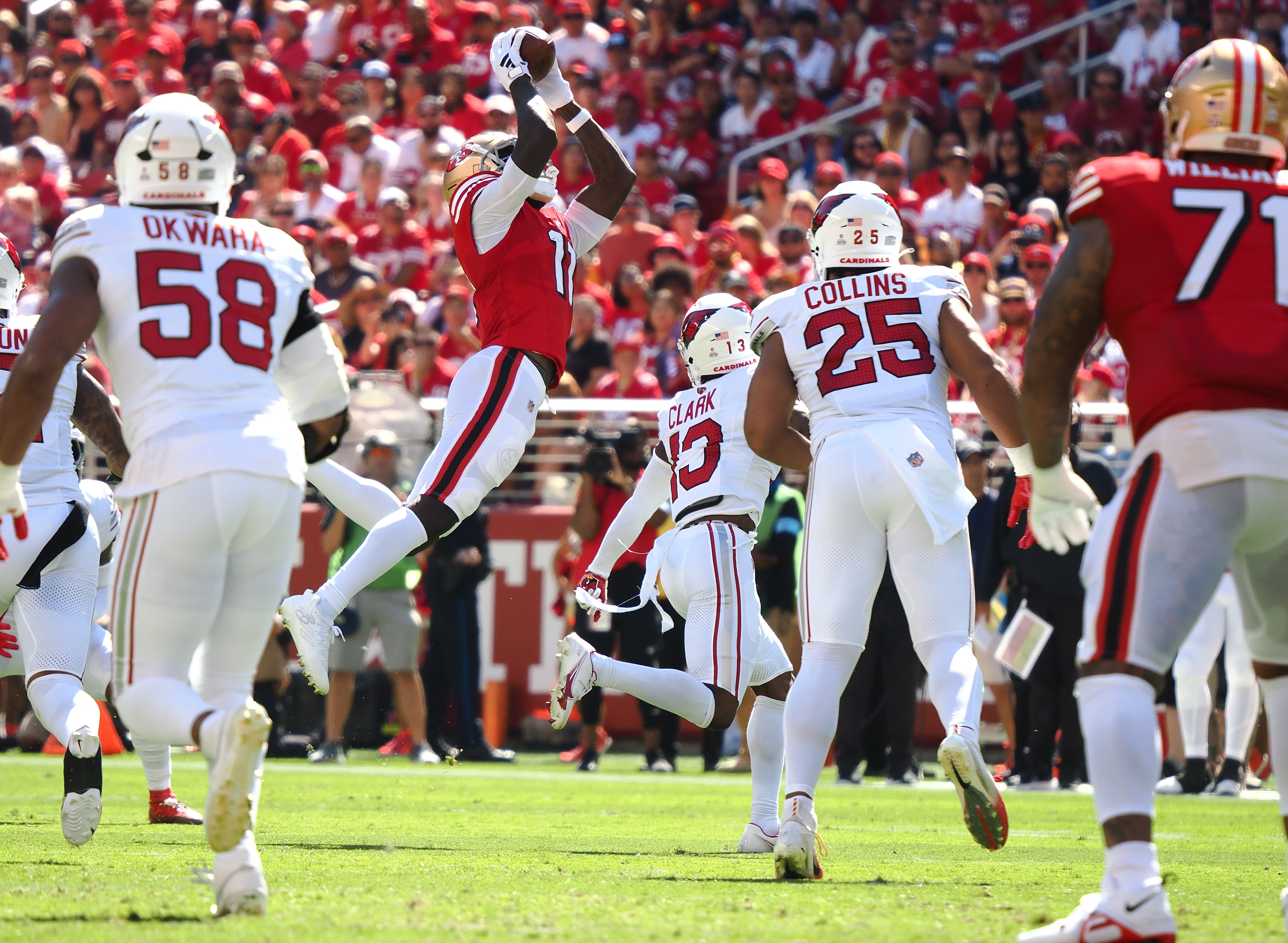 San Francisco 49ers wide receiver Brandon Aiyuk (11) catches the ball above Arizona Cardinals cornerback Kei'Trel Clark (13) during the first quarter at Levi's Stadium.