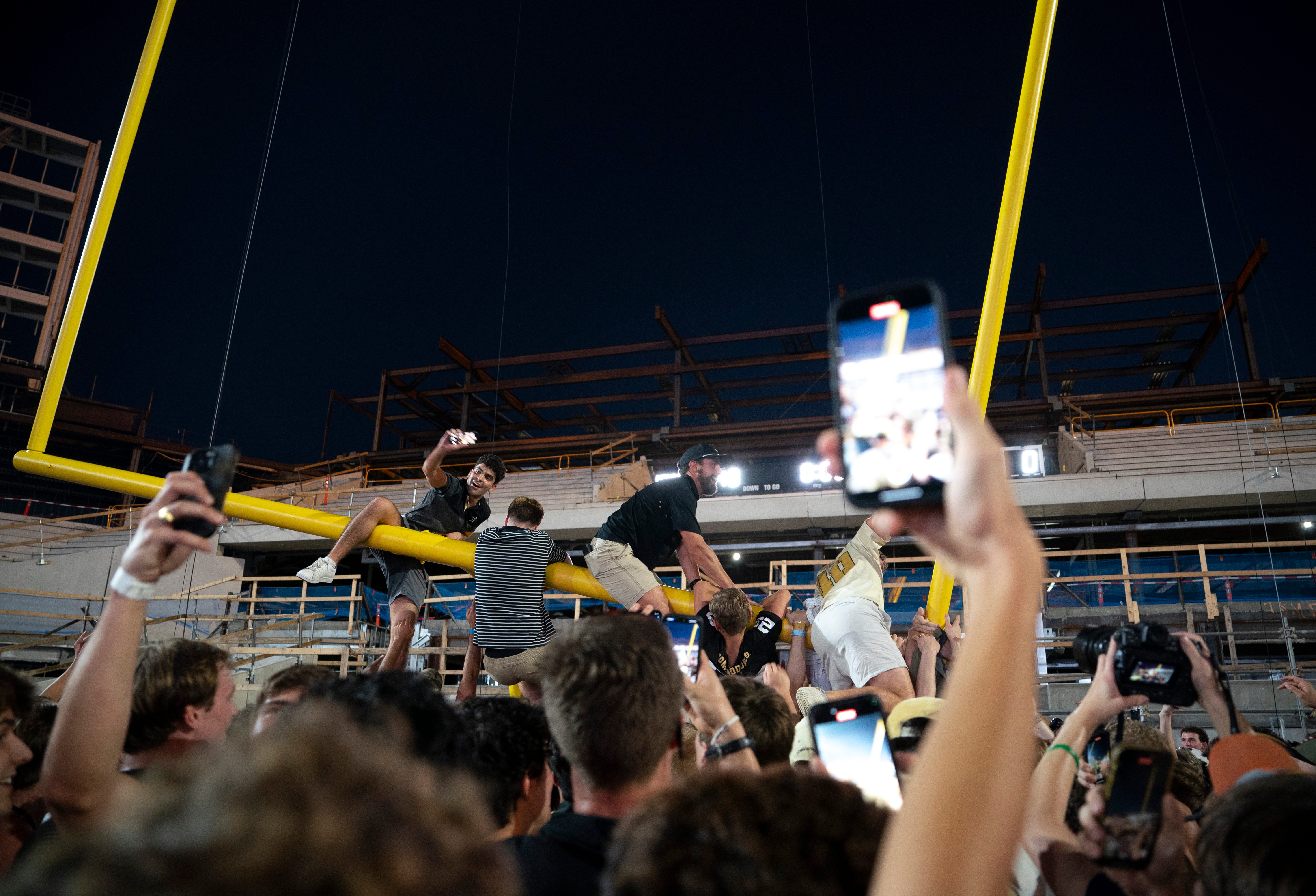 Exuberant fans ride the south goal post in the end zone after beating No. 1 Alabama 40-35 at Vanderbilt Stadium in Nashville, Tenn., Saturday, Oct. 5, 2024.