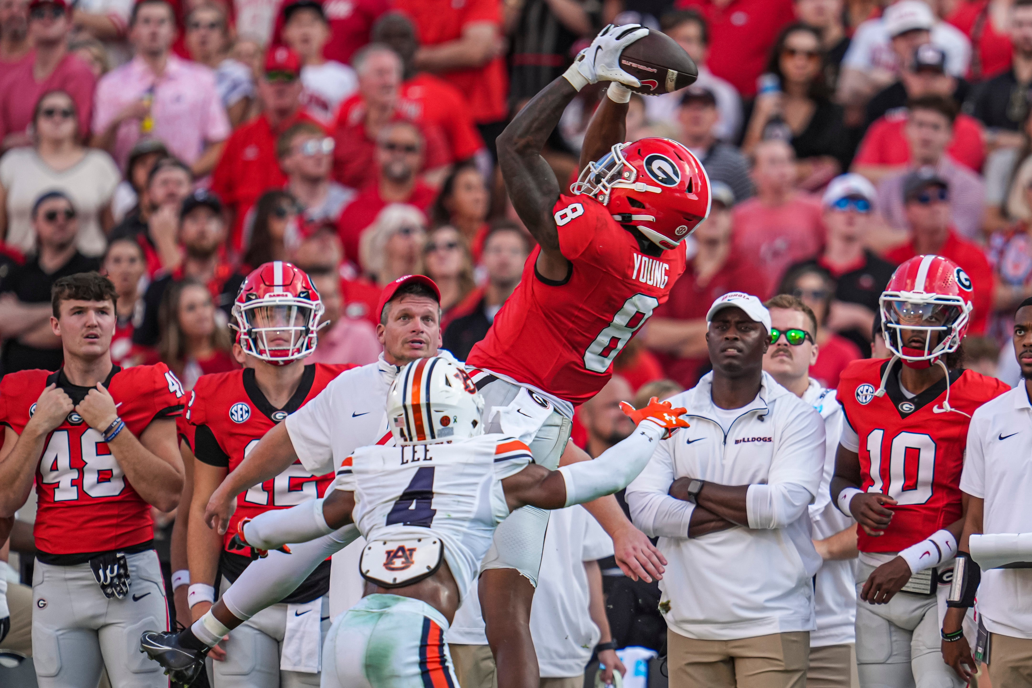 Oct 5, 2024; Athens, Georgia, USA; Georgia Bulldogs wide receiver Colbie Young (8) makes a catch over Auburn Tigers cornerback Kayin Lee (4) at Sanford Stadium.