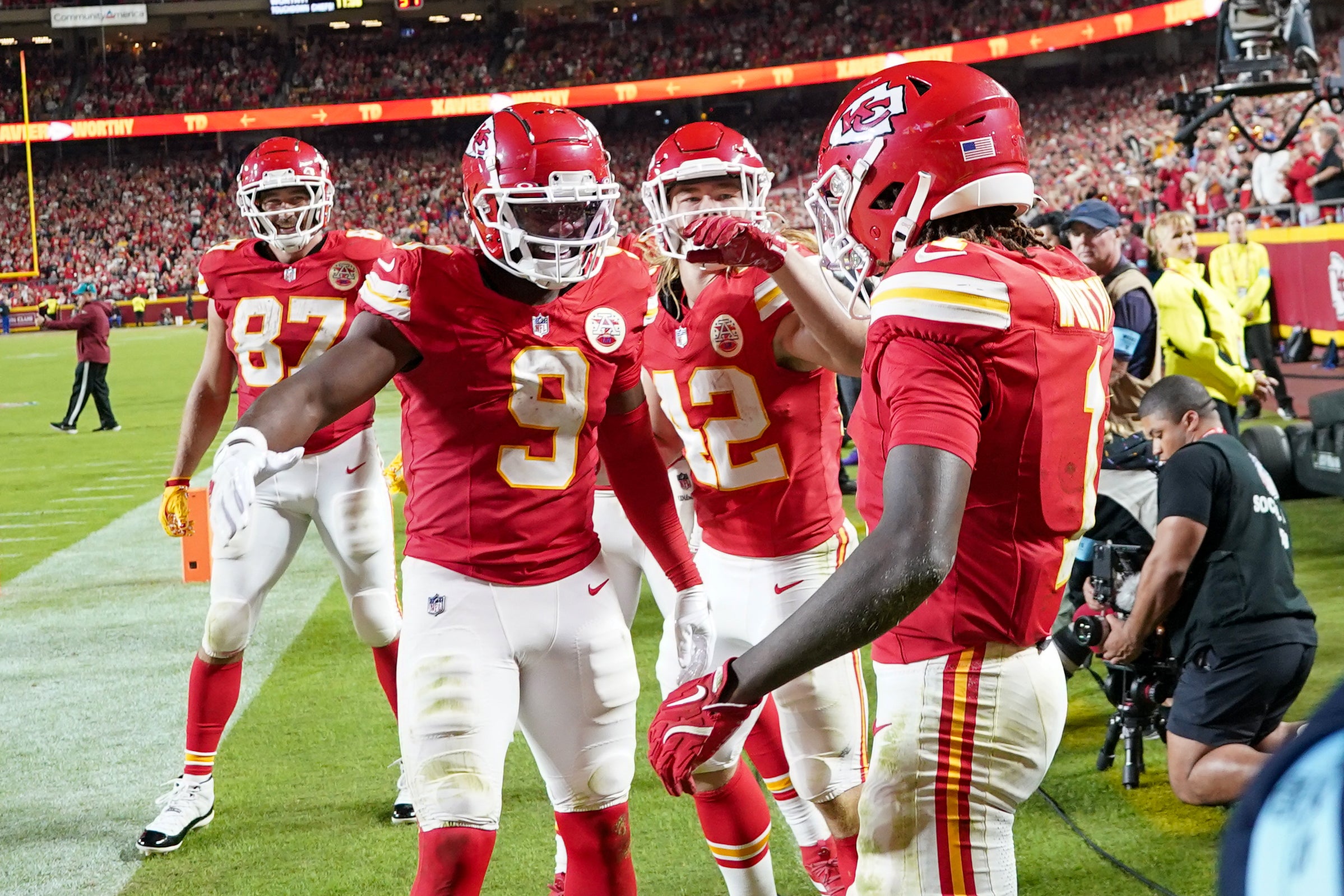 Oct 7, 2024; Kansas City, Missouri, USA; Kansas City Chiefs wide receiver Xavier Worthy (1) celebrates with wide receiver JuJu Smith-Schuster (9) and running back Carson Steele (42) after scoring a touchdown against the New Orleans Saints during the second half at GEHA Field at Arrowhead Stadium.