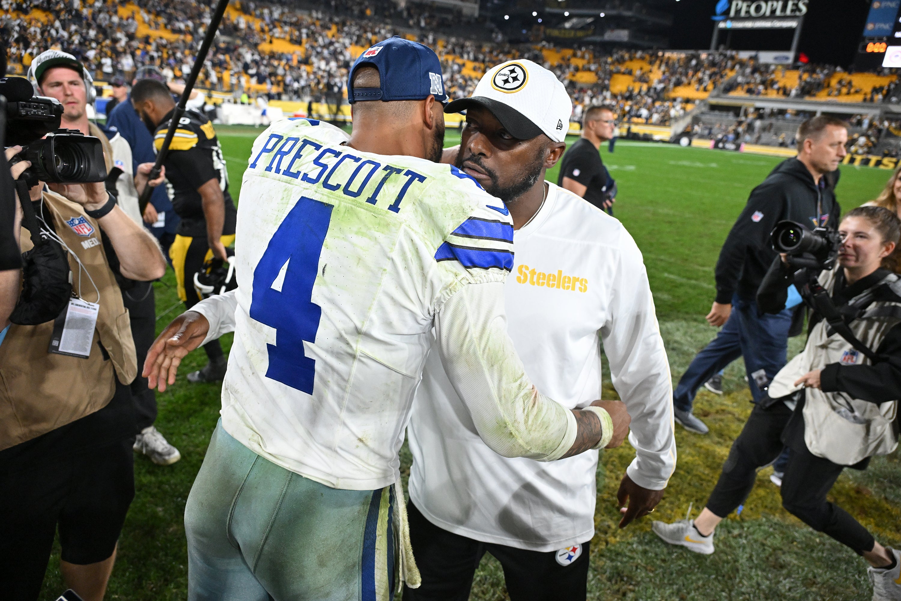 Dallas Cowboys quarterback Dak Prescott (4) greets Pittsburgh Steelers head coach Mike Tomlin following a 20-17 win at Acrisure Stadium.