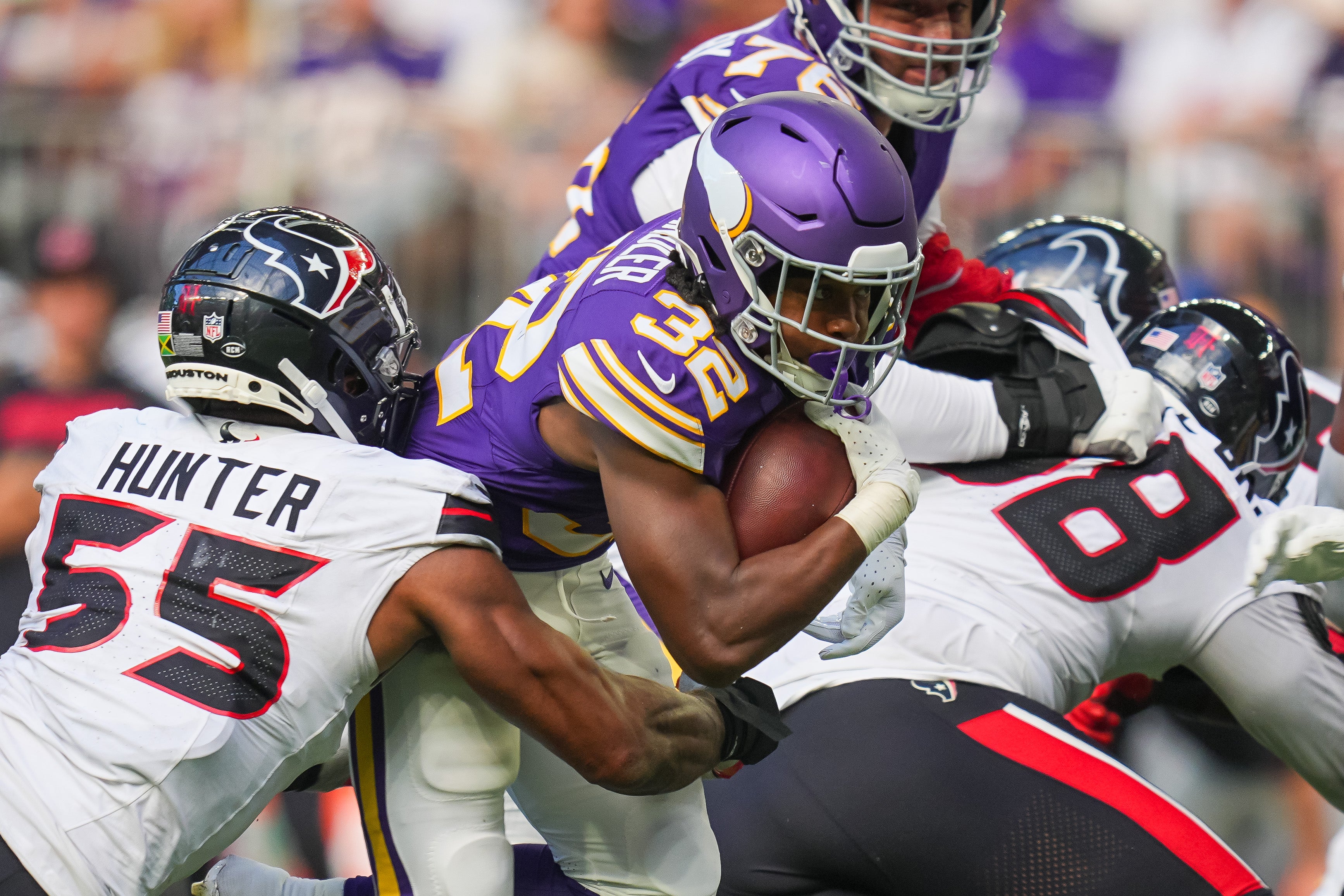 Sep 22, 2024; Minneapolis, Minnesota, USA; Minnesota Vikings running back Ty Chandler (32) runs with the ball against the Houston Texans in the third quarter at U.S. Bank Stadium.