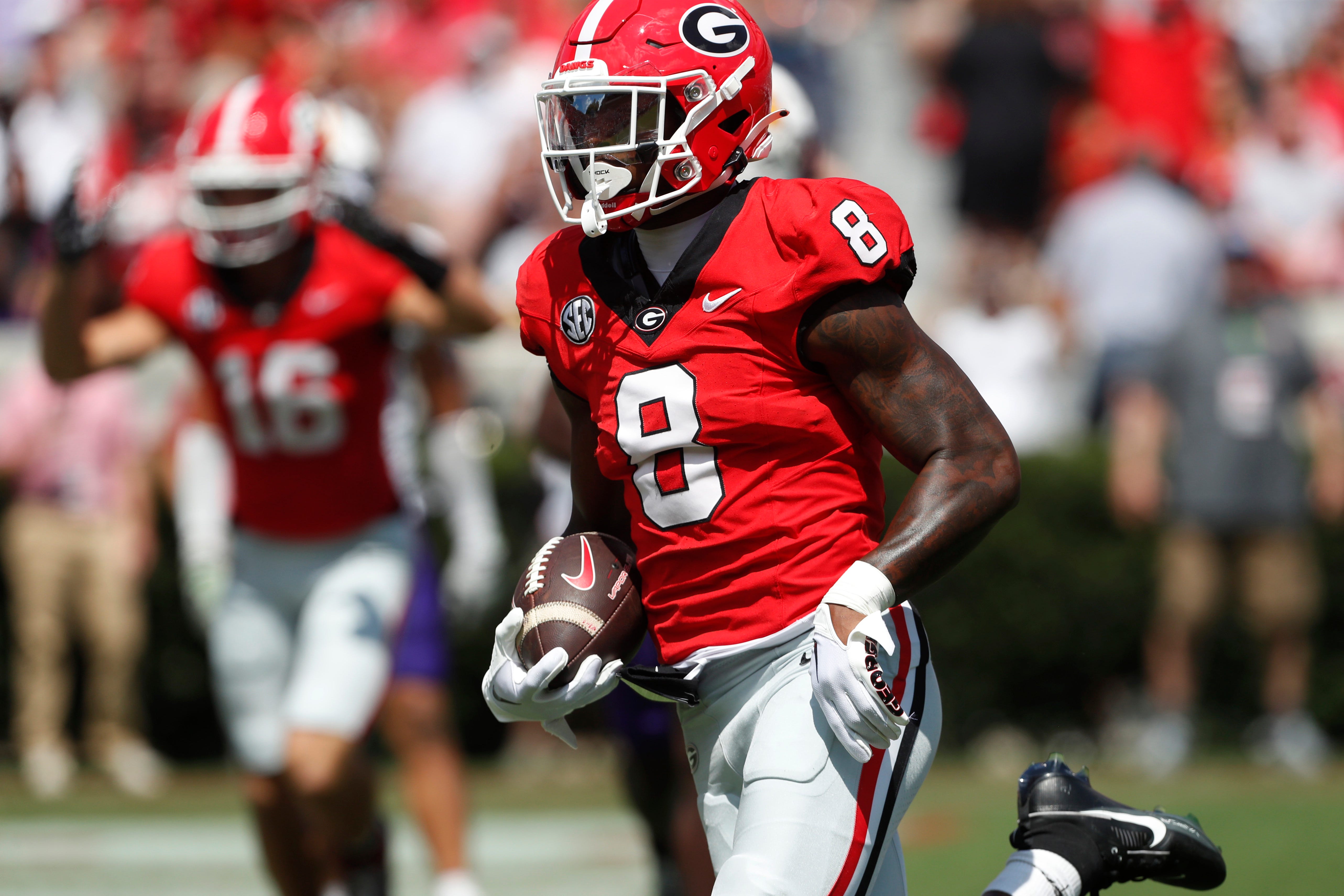 Georgia wide receiver Colbie Young (8) drives in to score a touchdown after pulling in a pass from Georgia quarterback Carson Beck (15) during the first half of a NCAA college football game.
