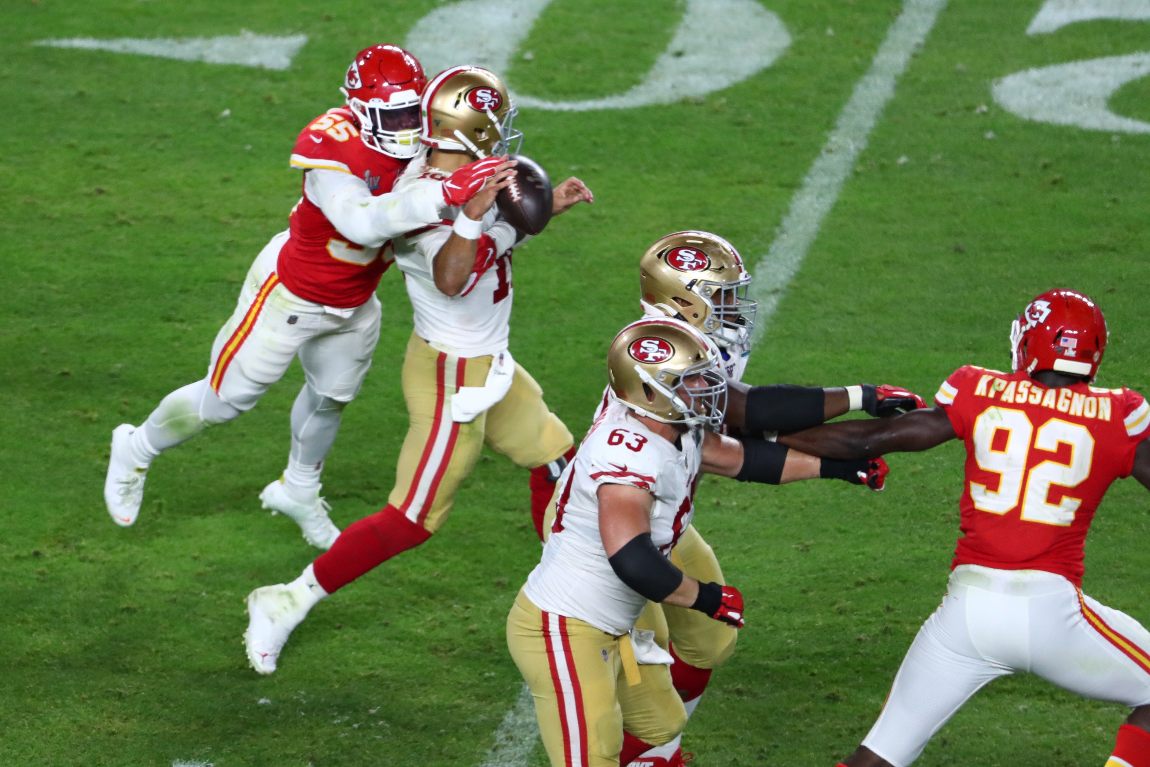 Feb 2, 2020; Miami Gardens, Florida, USA; Kansas City Chiefs defensive end Frank Clark (55) knocks the ball loose from San Francisco 49ers quarterback Jimmy Garoppolo (10) in Super Bowl LIV at Hard Rock Stadium.