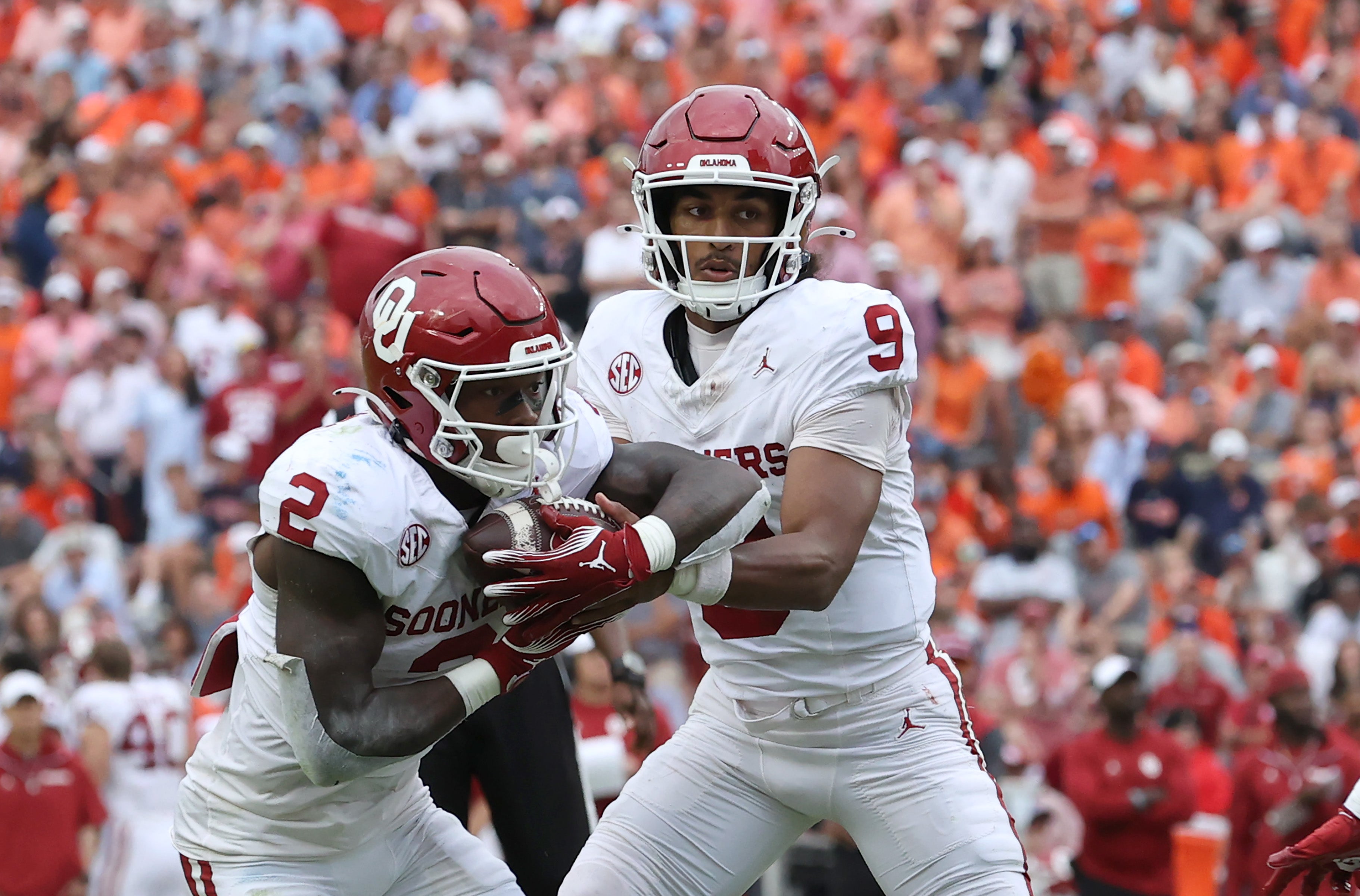 Sep 28, 2024; Auburn, Alabama, USA; Oklahoma Sooners quarterback Michael Hawkins Jr. (9) hands off to running back Jovantae Barnes (2) during the third quarter against the Auburn Tigers at Jordan-Hare Stadium.