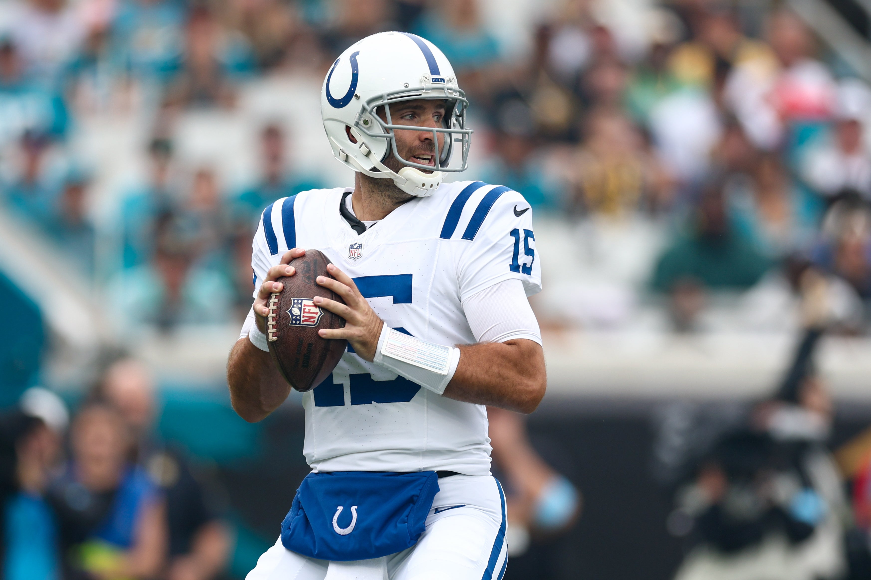 Oct 6, 2024; Jacksonville, Florida, USA; Indianapolis Colts quarterback Joe Flacco (15) drops back to passs against the Jacksonville Jaguars in the first quarter at EverBank Stadium. Mandatory Credit: Nathan Ray Seebeck-Imagn Images