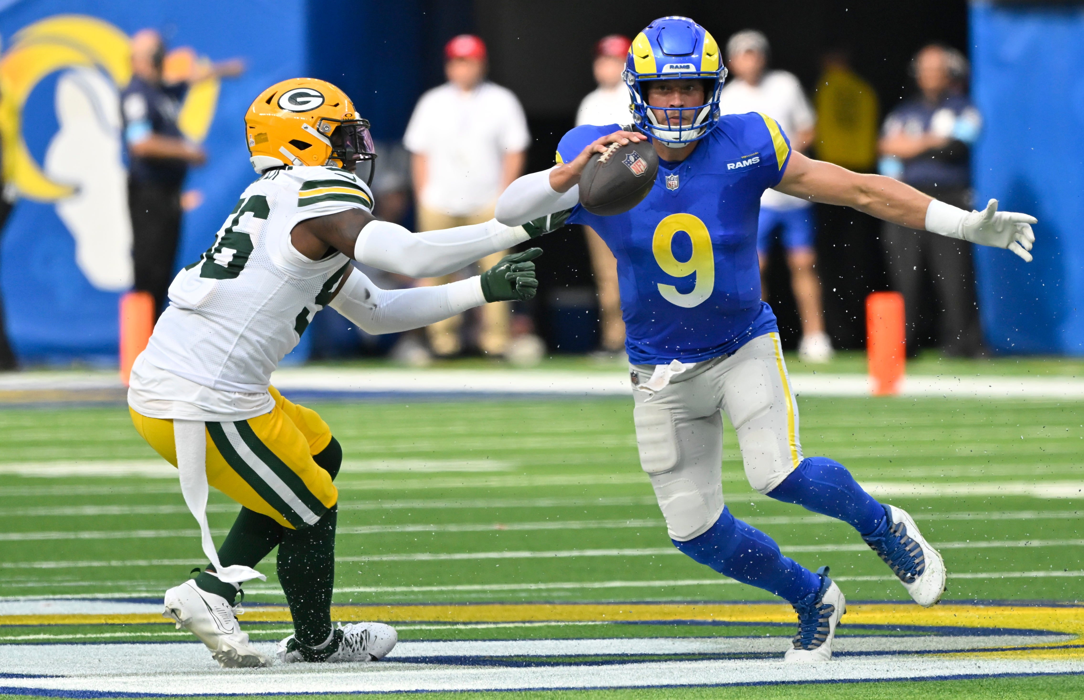 Green Bay Packers linebacker Edgerrin Cooper (56) grabs Los Angeles Rams quarterback Matthew Stafford (9) behind the line of scrimmage during the second quarter at SoFi Stadium.