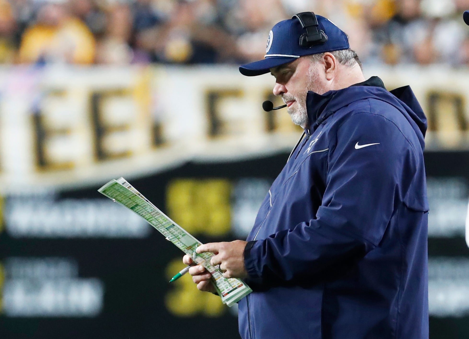 Dallas Cowboys head coach Mike McCarthy looks at his play chart against the Pittsburgh Steelers during the second quarter at Acrisure Stadium.